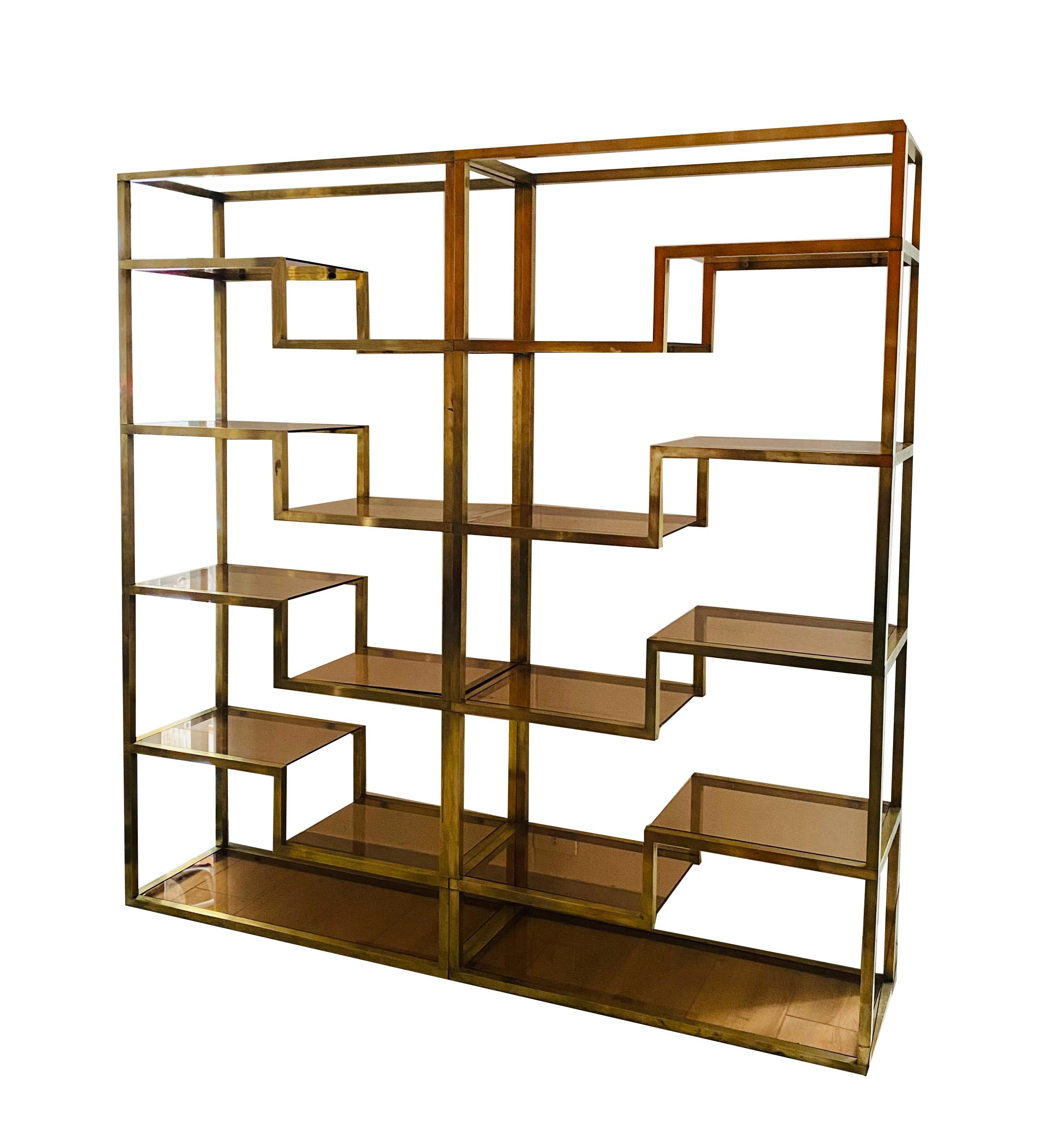 Italian etagere from the 1970s designed by Romeo Rega with a large rectangular shape, the brass structure supports several light brown glass shelves'. It consists of two etagere tables placed side by side, which can be arranged as desired, if
