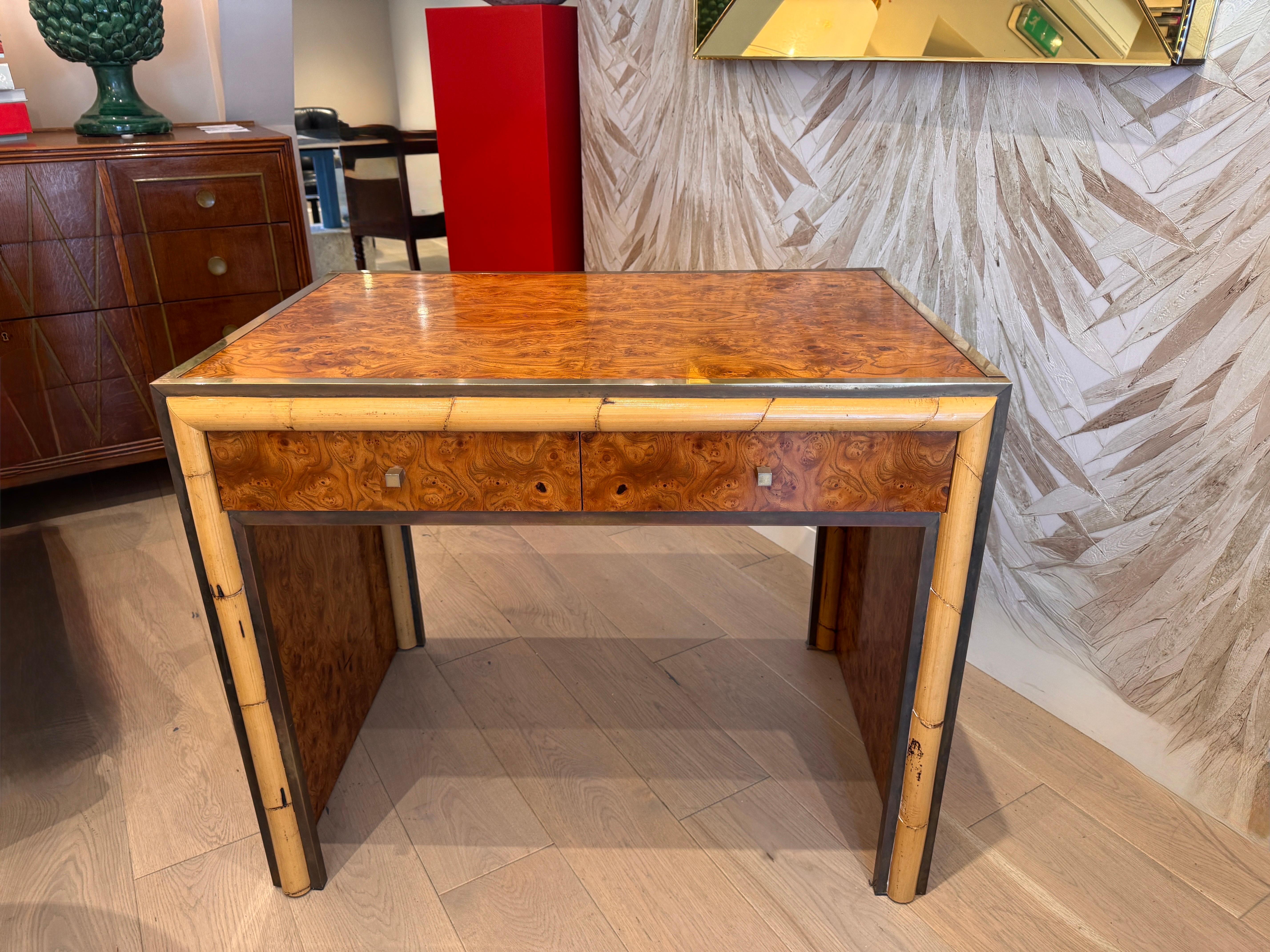 Beautifully finished small desk or vanity table by Romeo REGA  . Burr walnut surrounded by brass borders on all sides   Two drawers to the front with real banboo detailing .  
Italy C1970s 