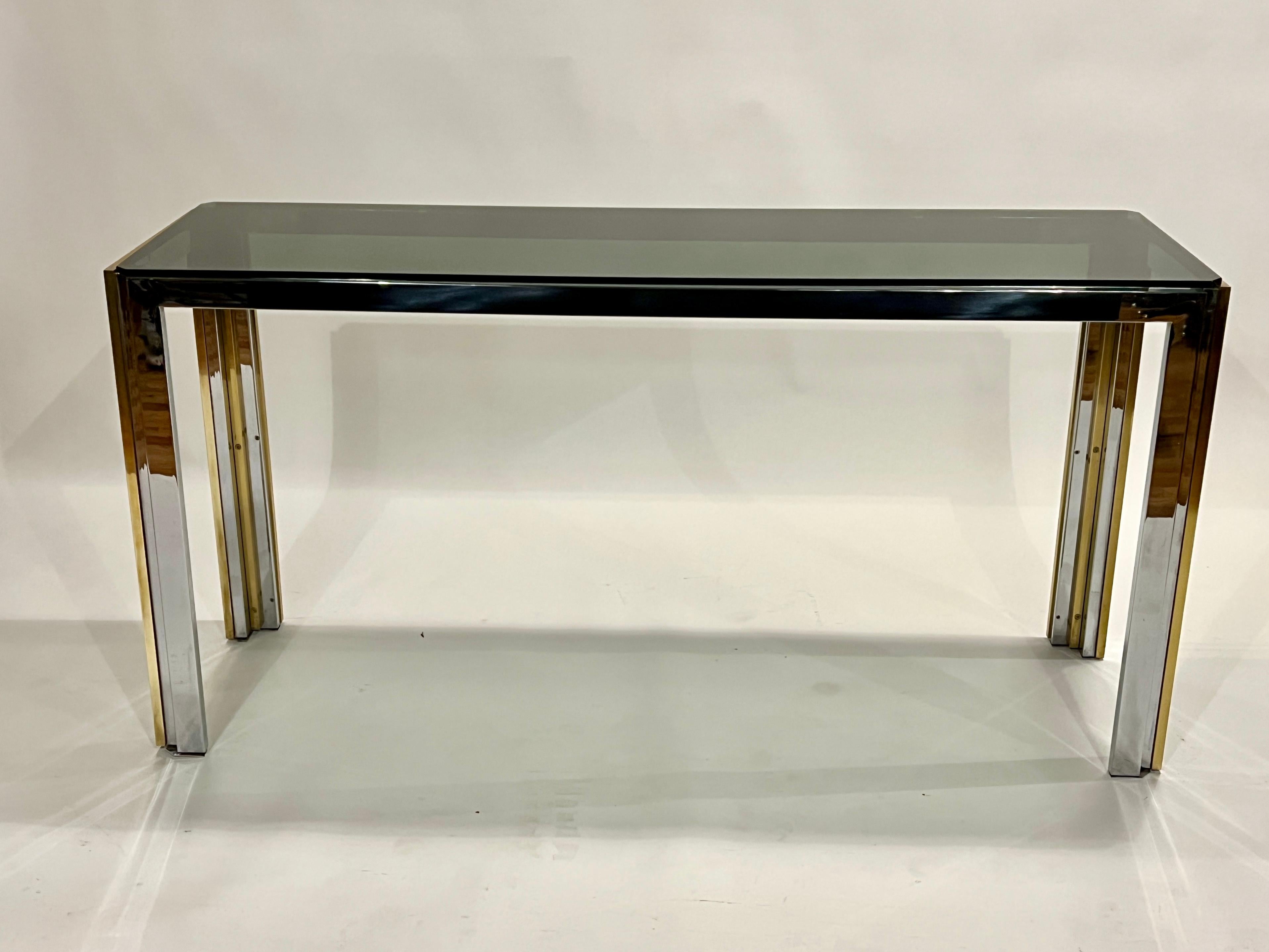 Brass and chrome console table attributed to Romeo Rega with smoked glass top and skyscraper designed legs.  