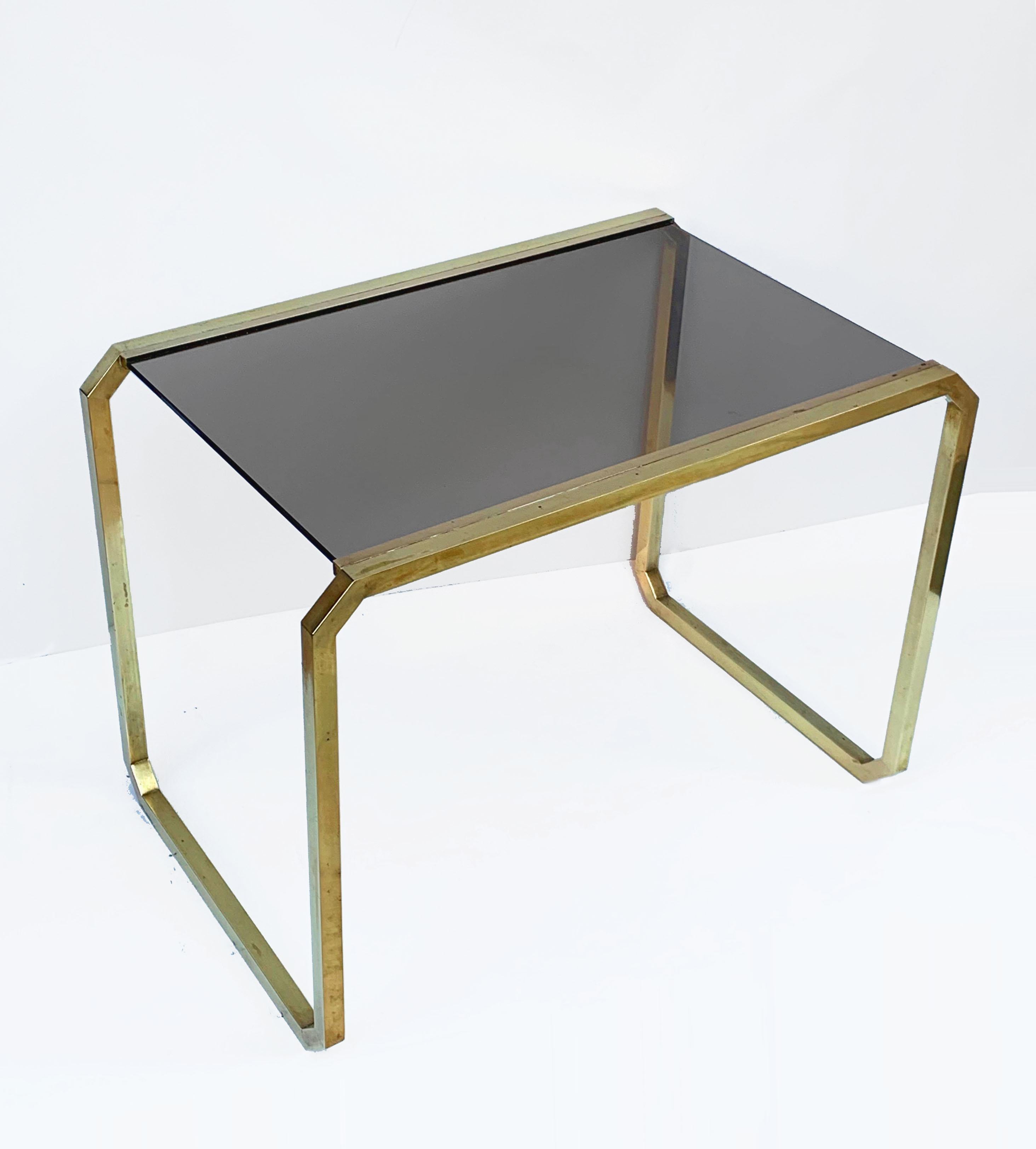 Elegant coffee table in brass, smoked glass adds to the seductive elegance of this midcentury piece.
Measurements: 56 x 36 H 41.