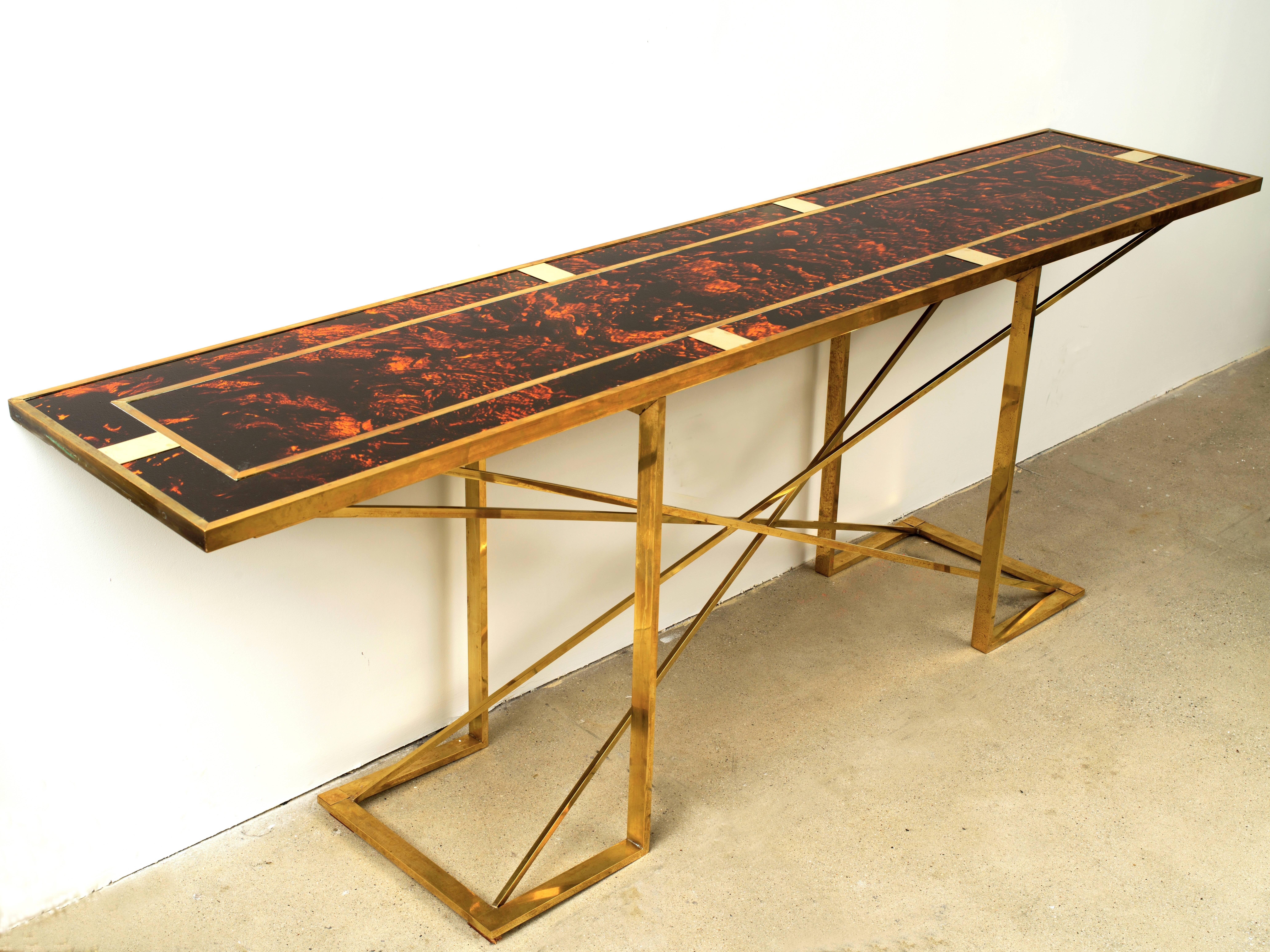 Stunning and dramatic is this large faux tortoise and brass console table attributed to Romeo Rega. The combination of the bright faux tortoise resin with the geometric lines of the brass creates a unique table to say the least. Found in Italy this