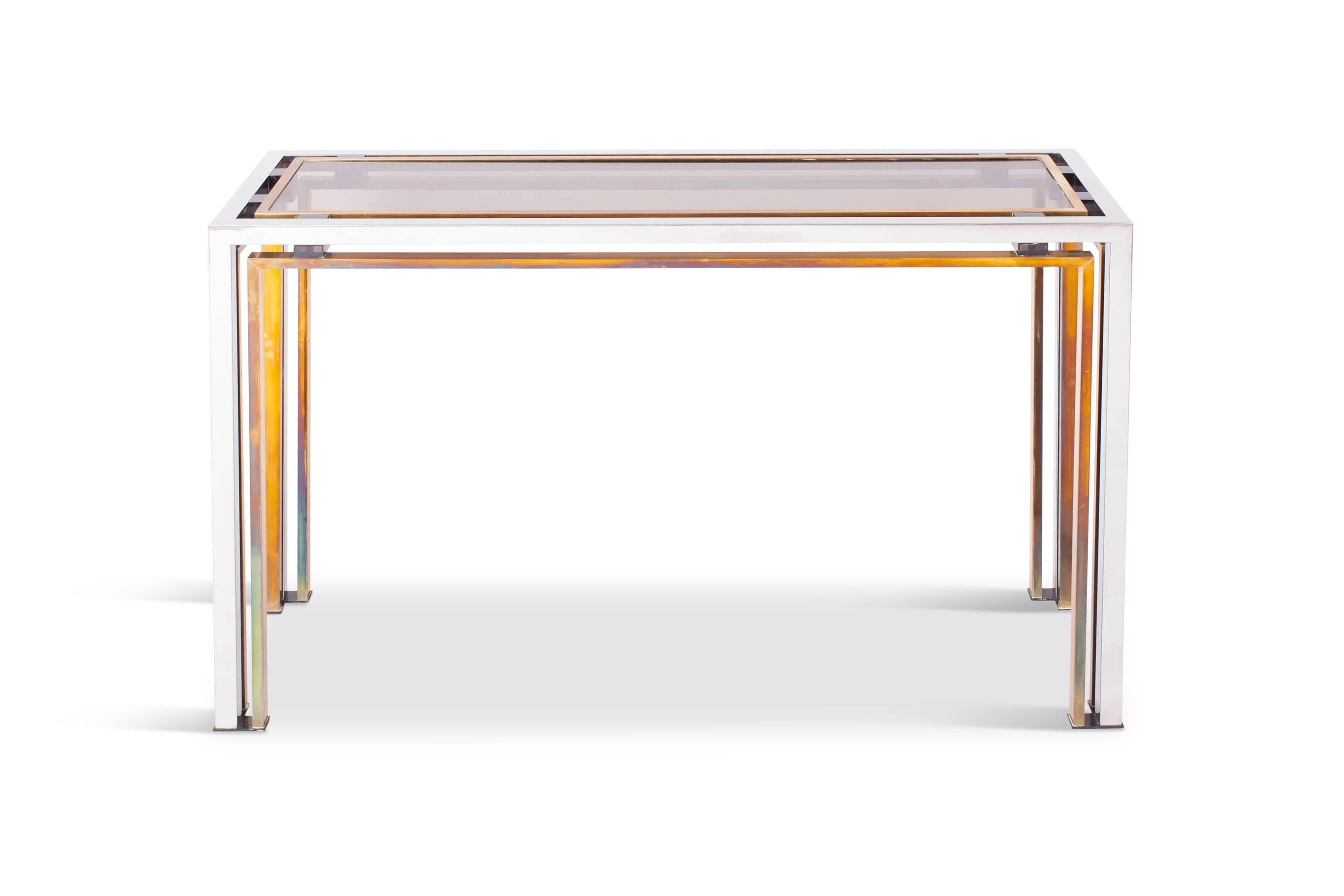 Hollywood Regency Mid-Century Modern console table by Italian designer Rome Rega, Italy, the 1970s.

The sculptural chrome and brass frame is contrasting nicely with the smoked glass top which is held in place with purple perspex