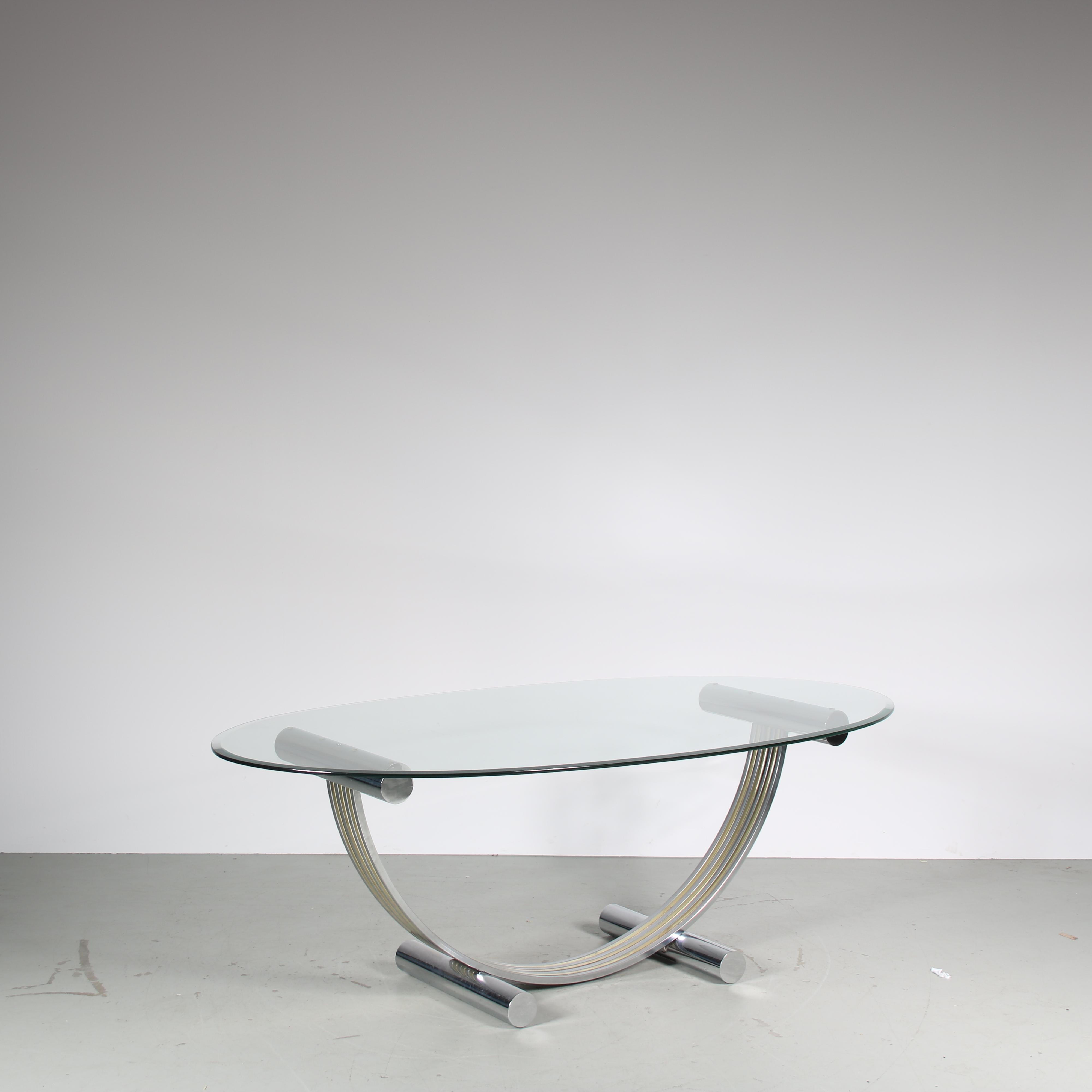A wonderful dining table, designed by Romeo Rega and manufactured in Italy around 1970.

The unique frame of the table has chrome plated, tubular metal legs and supports connected by a large half-circle shaped frame in chrome and gold plated metal.