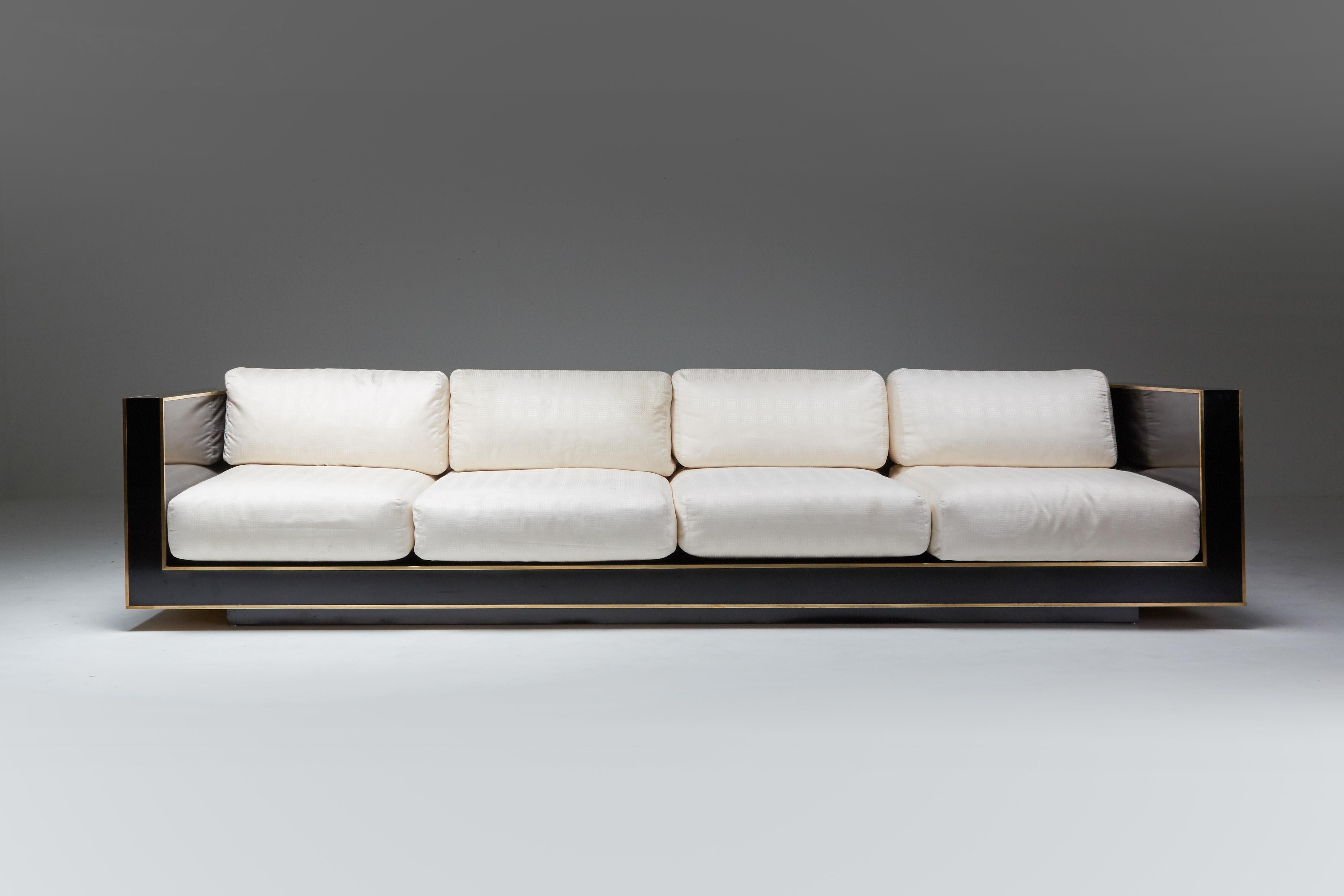 Hollywood Regency; Romeo Rega; Italy; 1970s; Four-Seater Sofa; Italian Design; Minimalist; Quality Italian Craftsmanship; Sophisticated Modernist Furniture;

High-end couch in black formica with solid brass linings. Its minimal design and strong