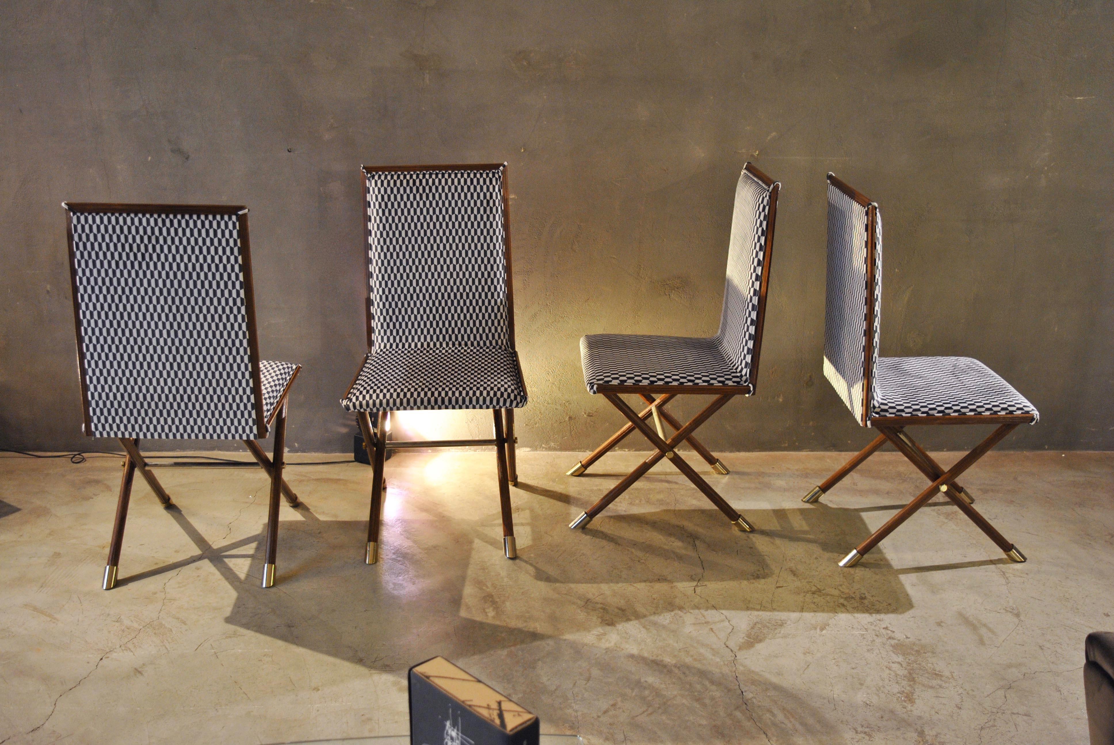 Midcentury wooden Italian chairs with brass fittings

Four wooden chairs with brass fittings covered in a new fabric with geometric patterns.