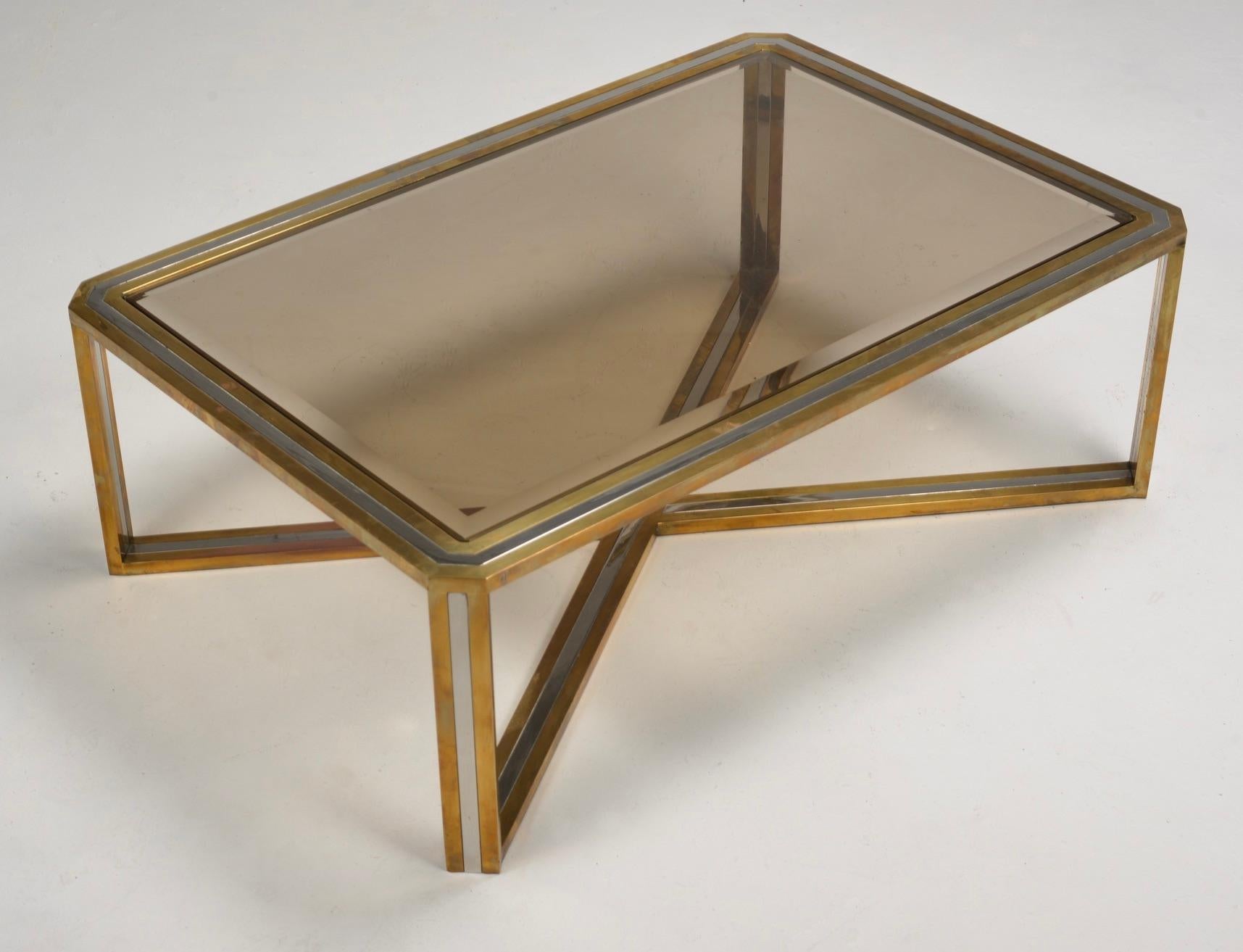 This beautiful table designed by Romeo Rega is made of steel, brass, and mirrored and smoked glass. Rega’s furniture is characterized by geometric shapes and simple forms. His designs are often gilded, chromed, or brass-plated. Rega is known for