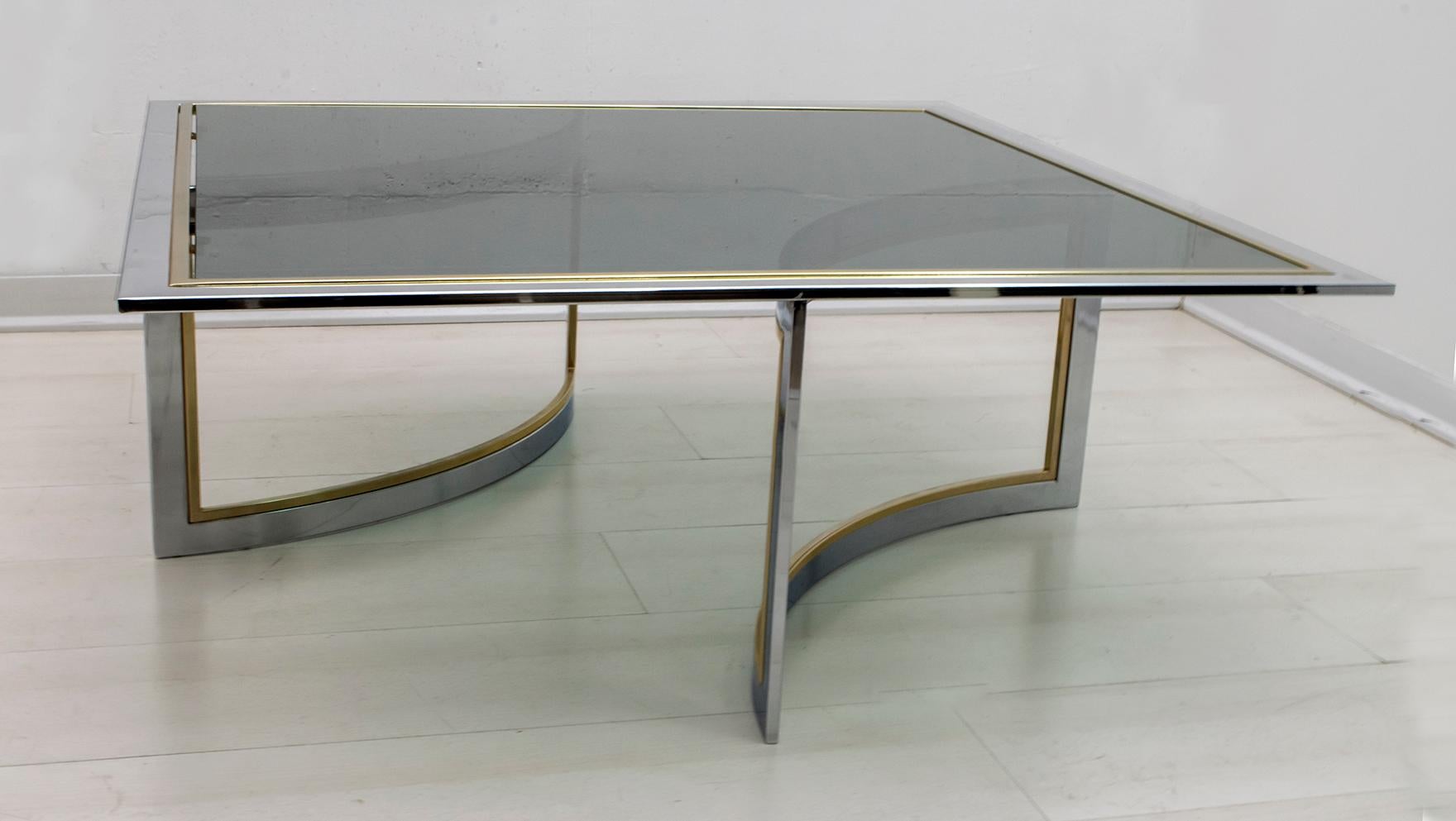 Bold and elegant Romeo Rega style chrome and brass coffee table. We love the combination of the chromed steel and gilt brass, especially when paired with the green glass top. We loved the architectural qualities of this strong piece and the