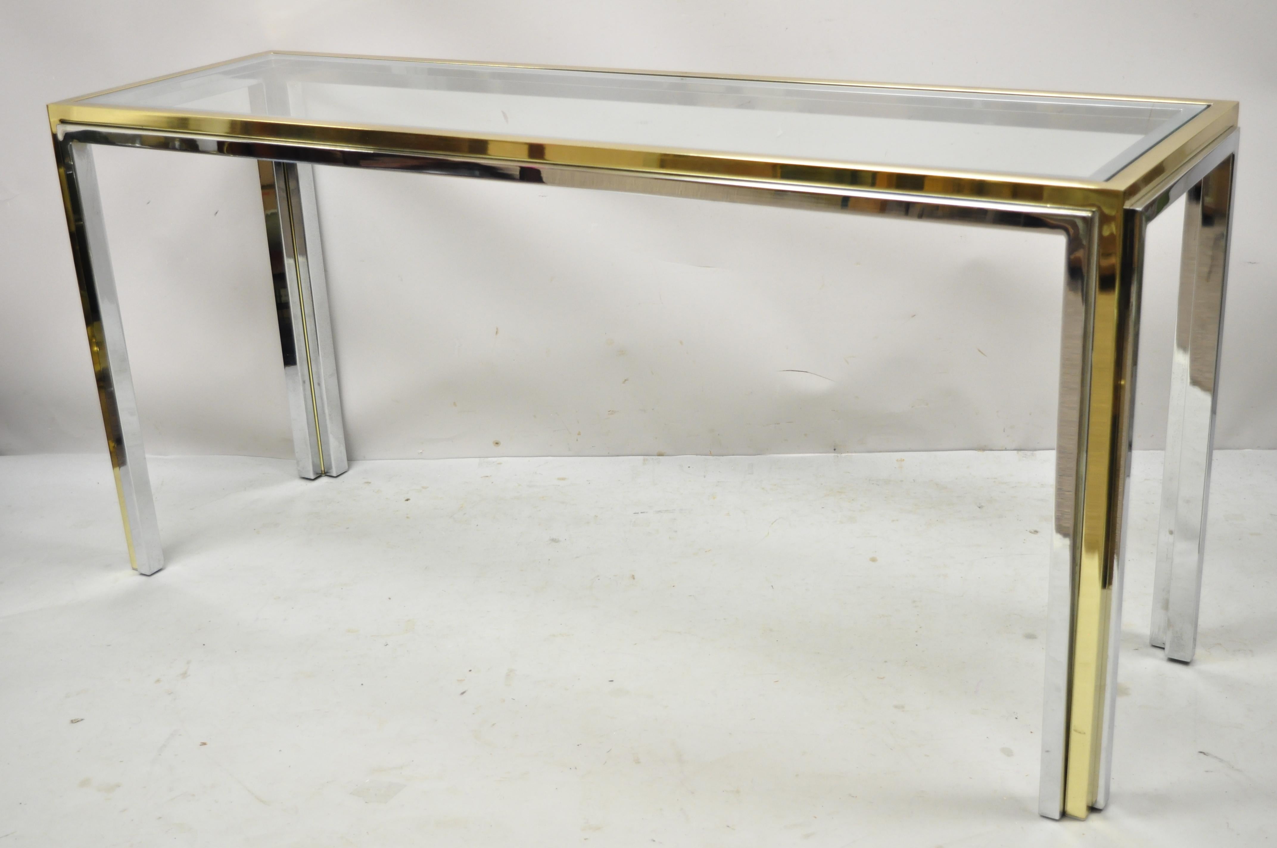 Vintage Romeo Rega Modern Maison Jansen Style Chrome and Brass Console Sofa Table. Item features chrome plated steel and brass sleek frame, inset glass top, very nice vintage item, clean modernist lines, quality Italian craftsmanship. Circa 1970s.