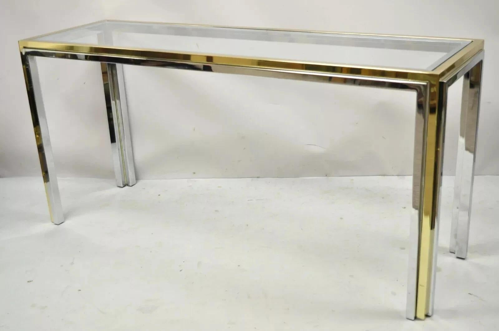 Vintage Romeo Rega Modernist Maison Jansen Style Chrome Brass Glass Console Hall Table. Item features a sleek chrome plated steel and brass frame, inset glass top, clean modernist lines, quality Italian craftsmanship. Circa Late 20th Century.