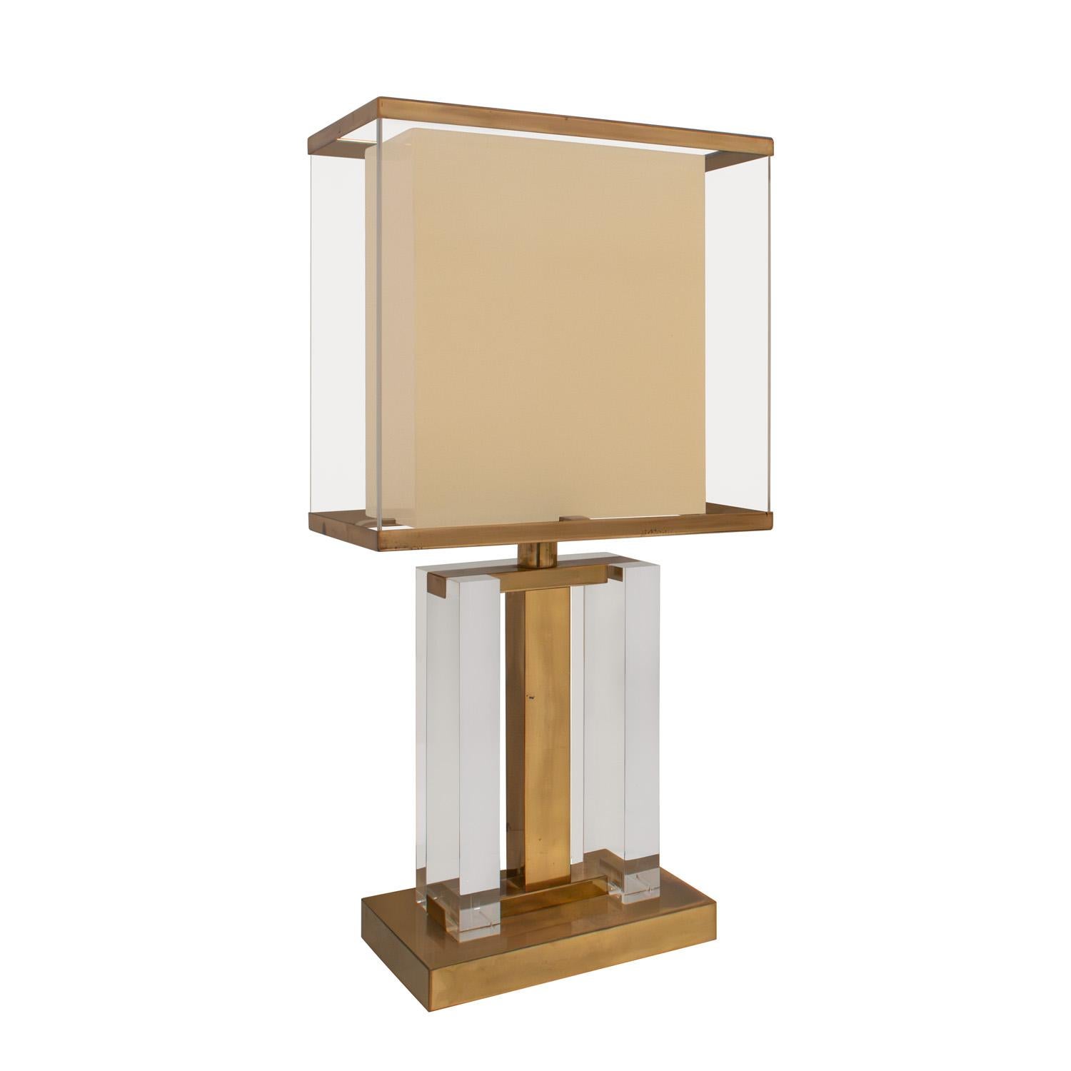 Stunning and rare pair of table lamps in brass and lucite with original encased lucite shades and brass trim by Romeo Rega, Italy 1970's. These lamps have striking details at every angle. They are architectural and beautifully crafted. The brass has