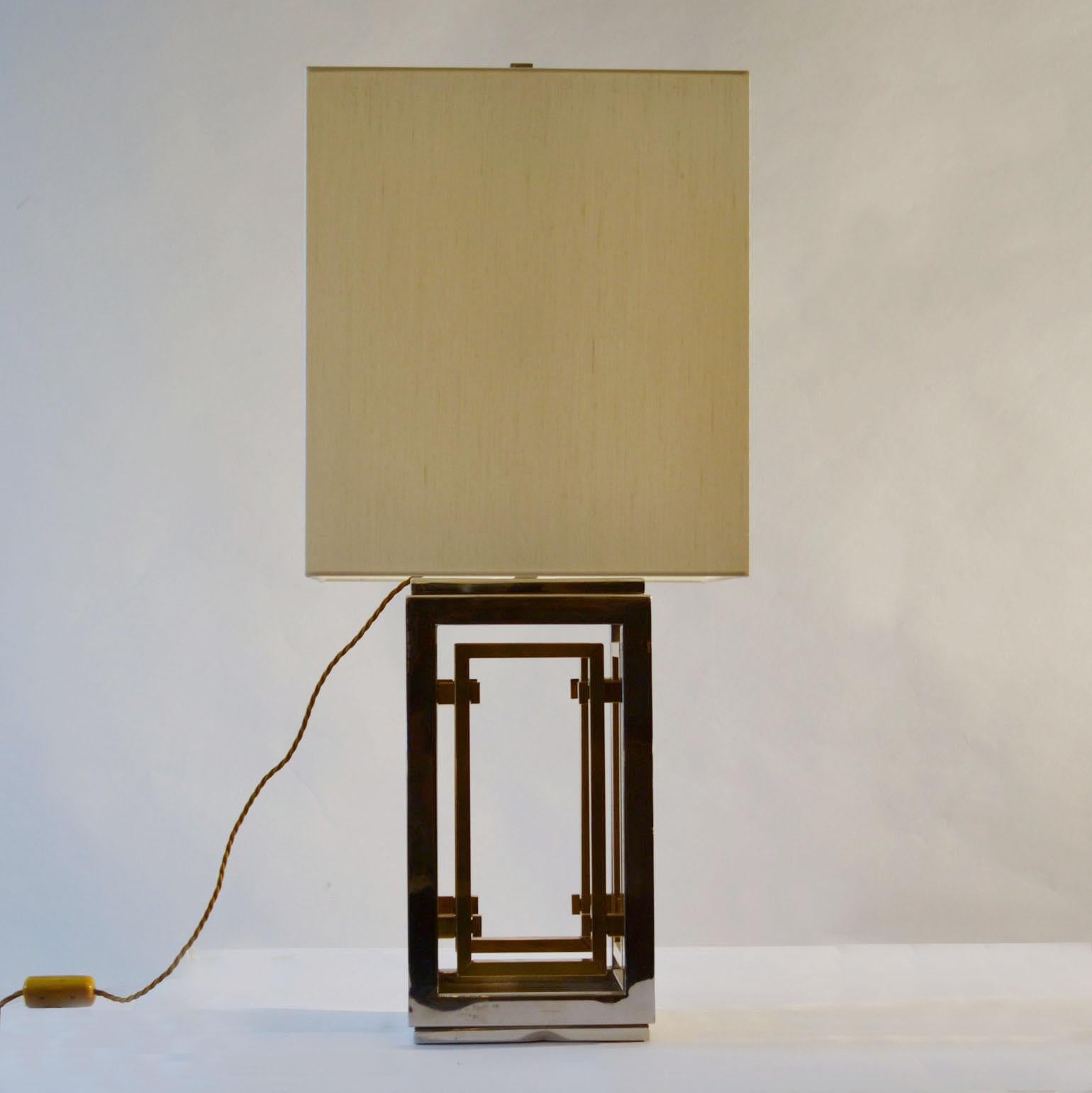 Large square geometrical pair of table lamps in alternating brass and chrome square tubes and new square cream lampshades. Mid Century Modern lamps by Italian Romeo Rega are ready to go.

The Italian Company Romeo Rega, 'the modern glam of its age',