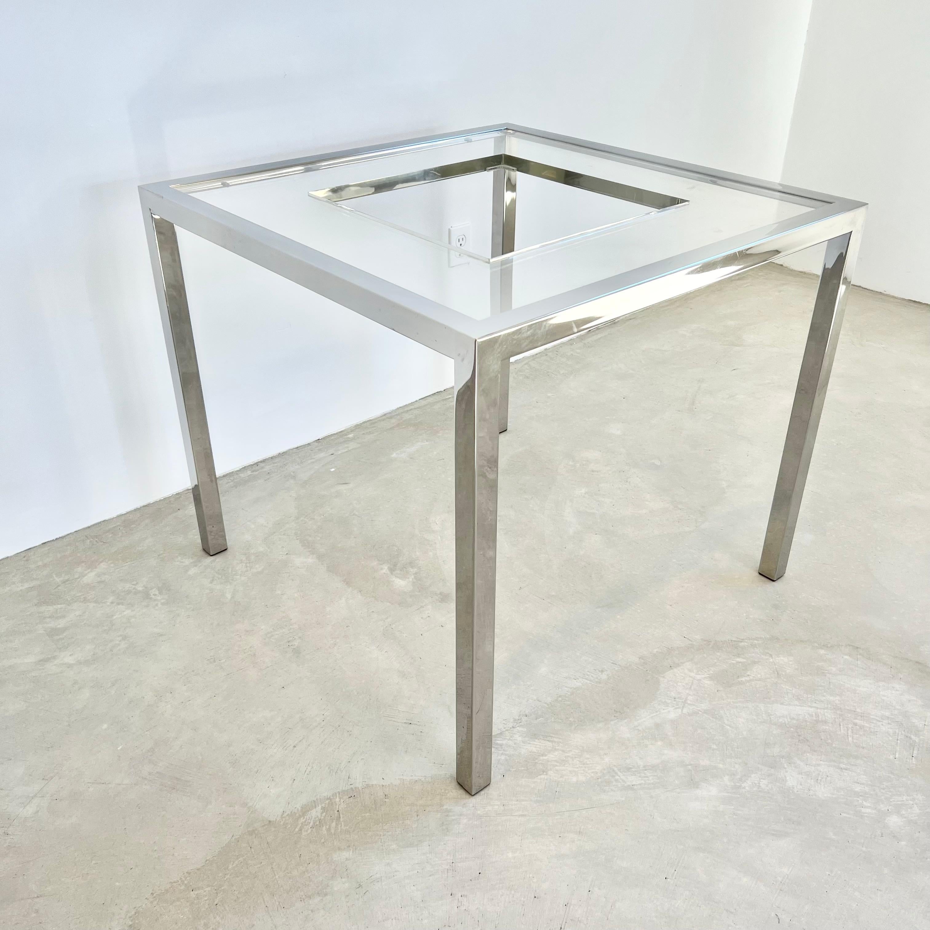 Elegant and beautiful chess table by Romeo Rega. Full chrome base with a thick, heavy, lucite inlay which supports the chess board. Perspex chess pieces are made with lucite bodies and differentiated by chrome metal accents or brass metal accents.