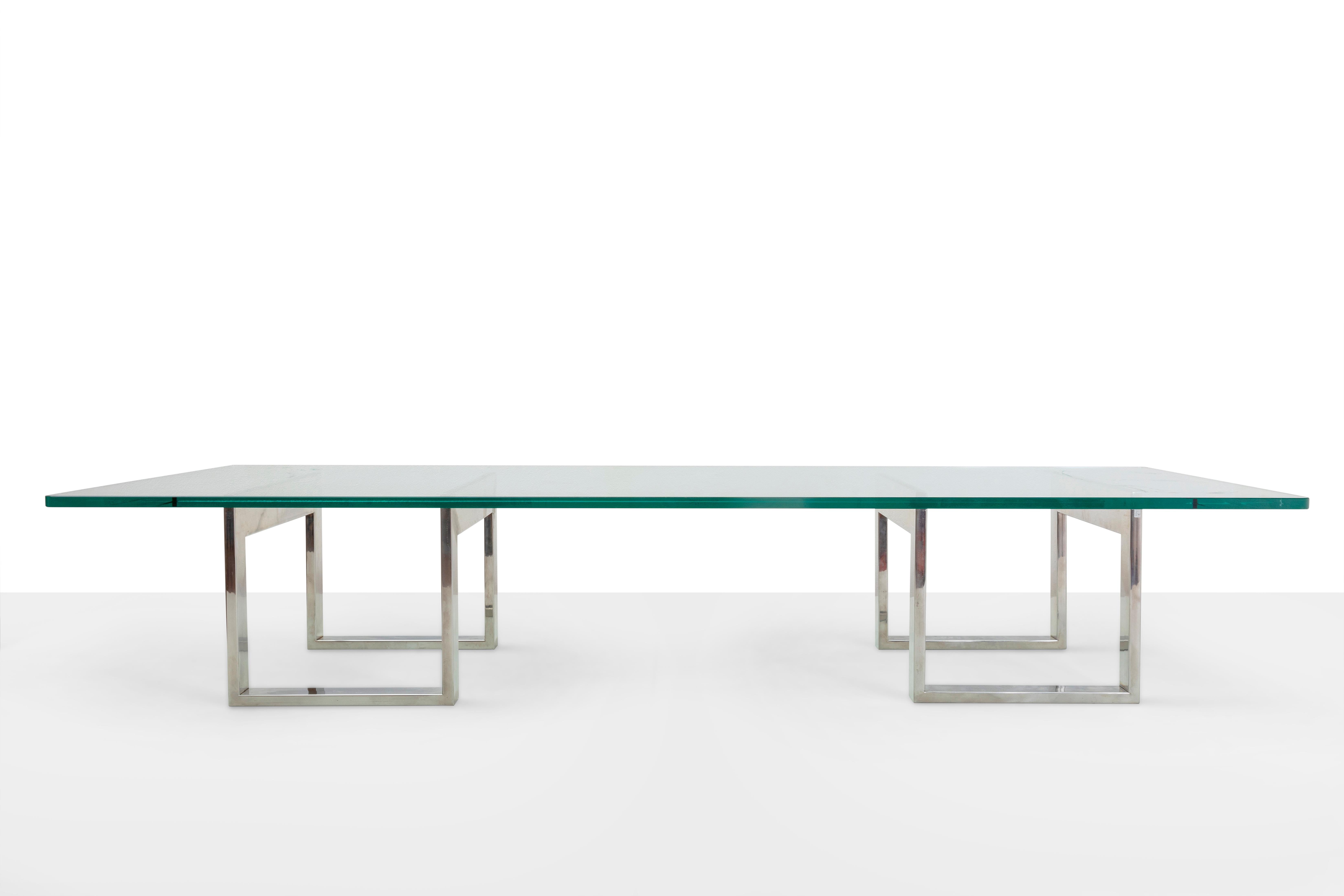 Romeo Rega Prod. Italy, c. 1970. Low table with beveled glass top and two chrome-plated steel bases. Cm glass 198x96 2 bases cm H 34 L 37,5
the attribution has been proven by reference bibliographies, archive photos of similar furniture.

Born in