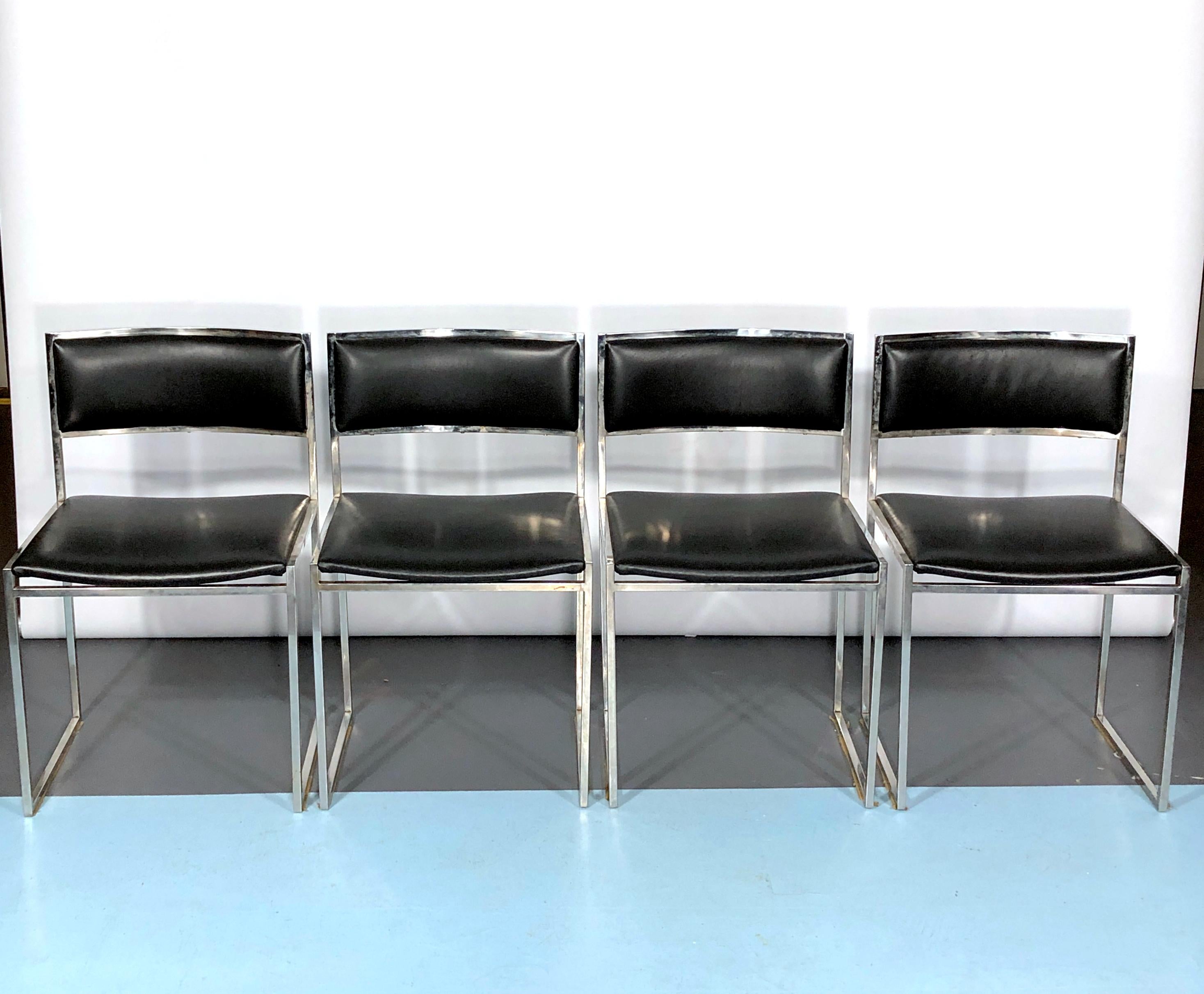 Chrome and black leather. Set of four dining chairs in excellent condition with some trace of age and use on the metal. Designed by Romeo Rega and produced in Italy during the 60s.