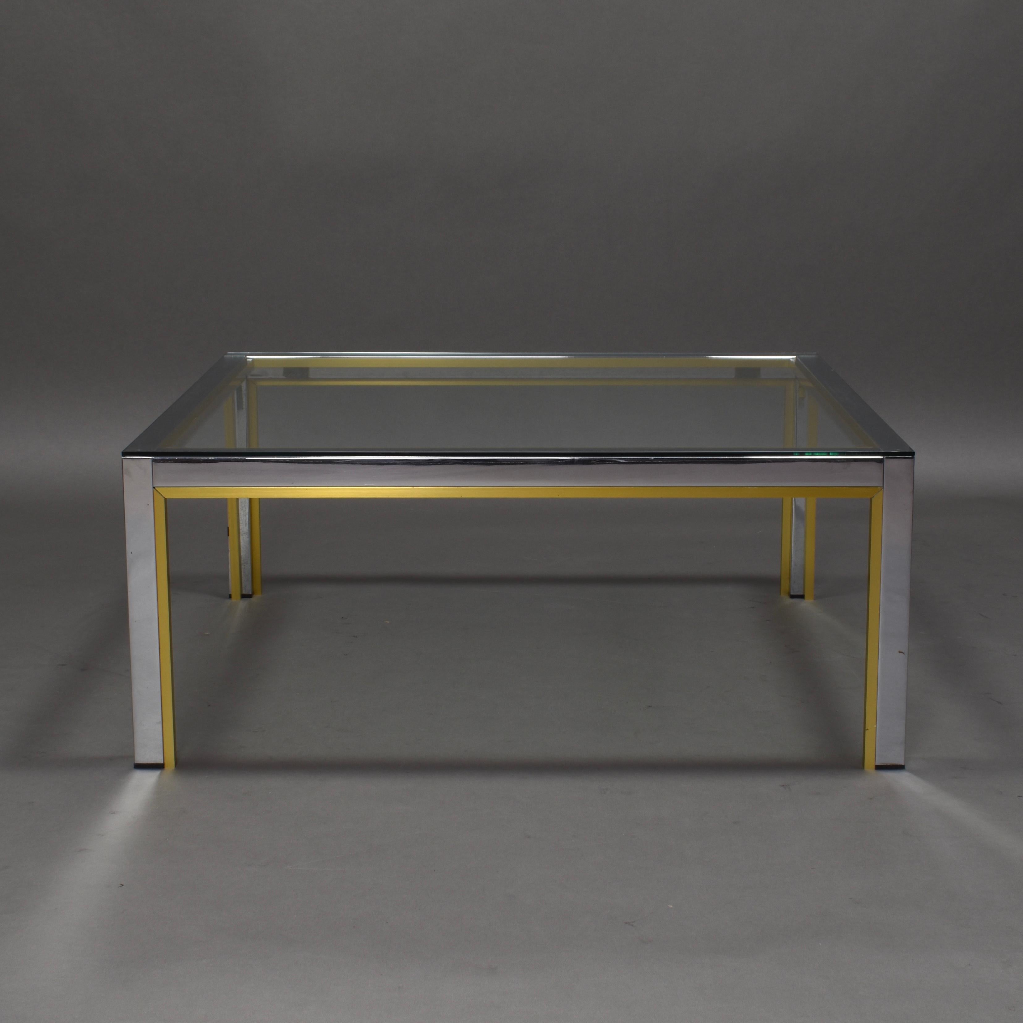 Nice square coffee table by the Italian manufacturer Romeo Rega.
The table is made of chrome and gold colored aluminum with a clear glass top.
It still remains in very good condition with some normal signs of age and use.