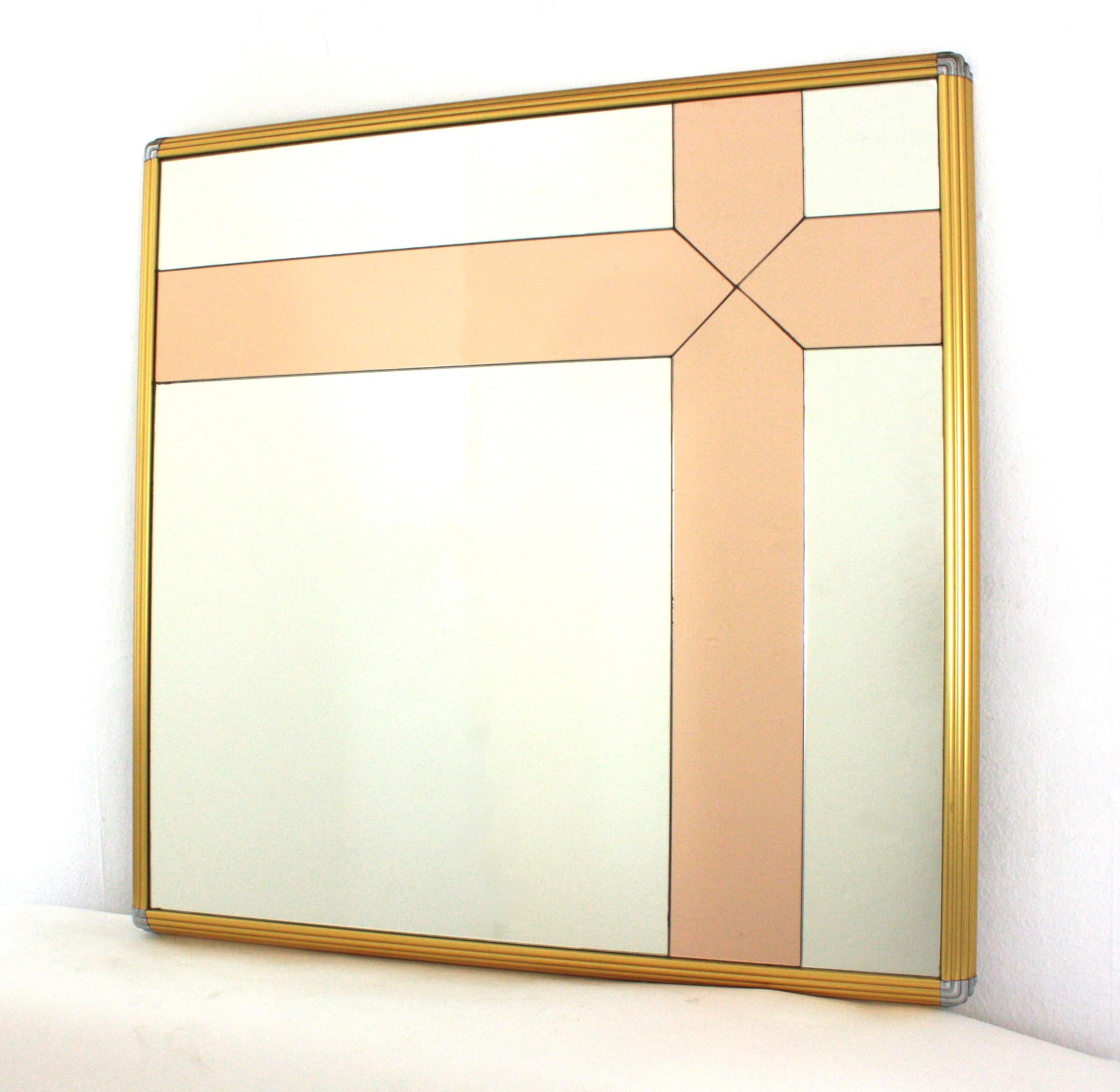 Square wall mirror or console mirror, brass, chrome steel,  smoked glass. Italy, 1970s.
This mirror is inspired in Romeo Rega designs. It features a brass scalloped frame with chrome details on the corners. It has a geometric decoration in pink rose