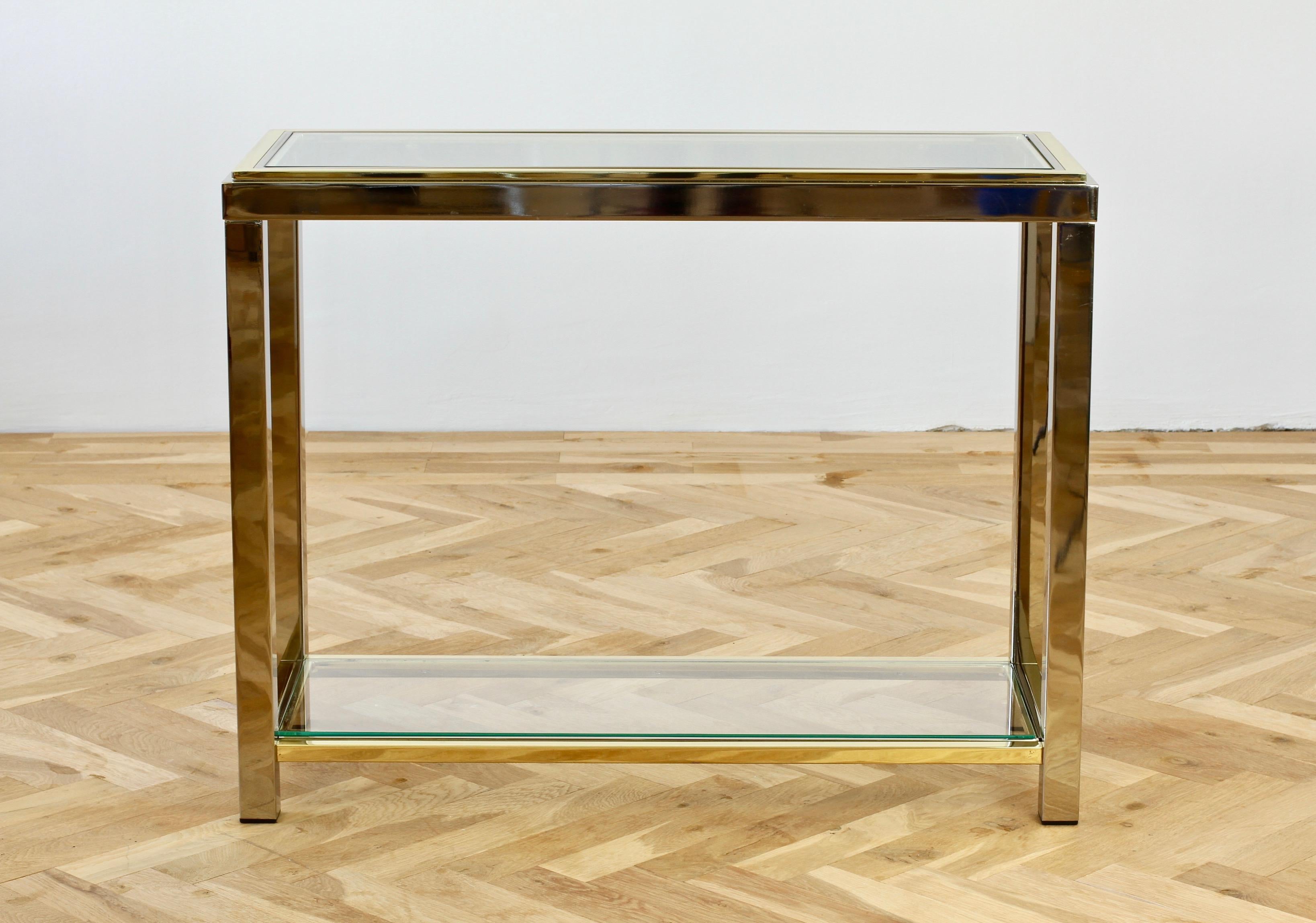 Brass and chrome-plated two-tiered console or hallway table, circa 1970s. Perfect for the Hollywood Regency style enthusiast or mid-century lover although, this table would sit very well indeed within any contemporary home decor design.

Not