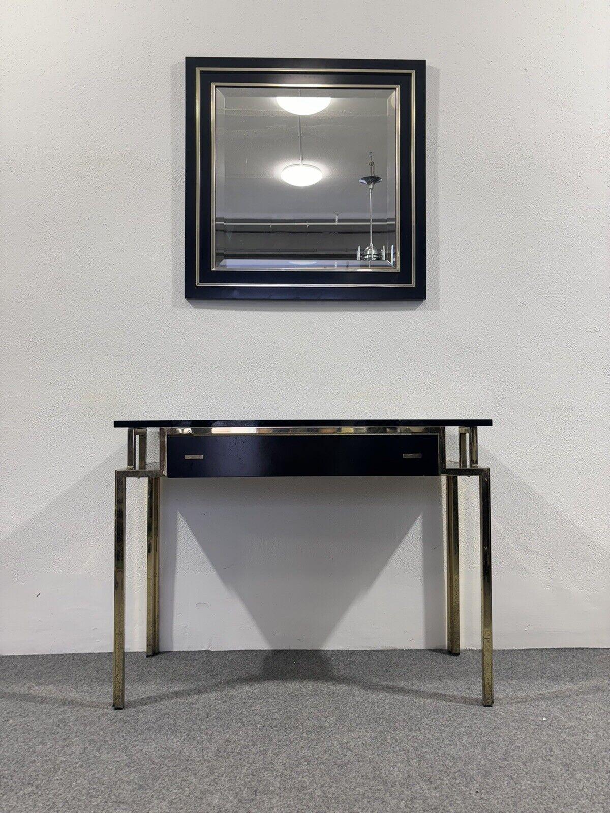 Romeo Rega Style Console Mirror Design Hollywood Regency Modernism 1970's.

Gold metal frame and black lacquered wood.

Item is in good vintage conservative condition, signs of time present due to use and age. (Please see photos)

Mirror 80x80