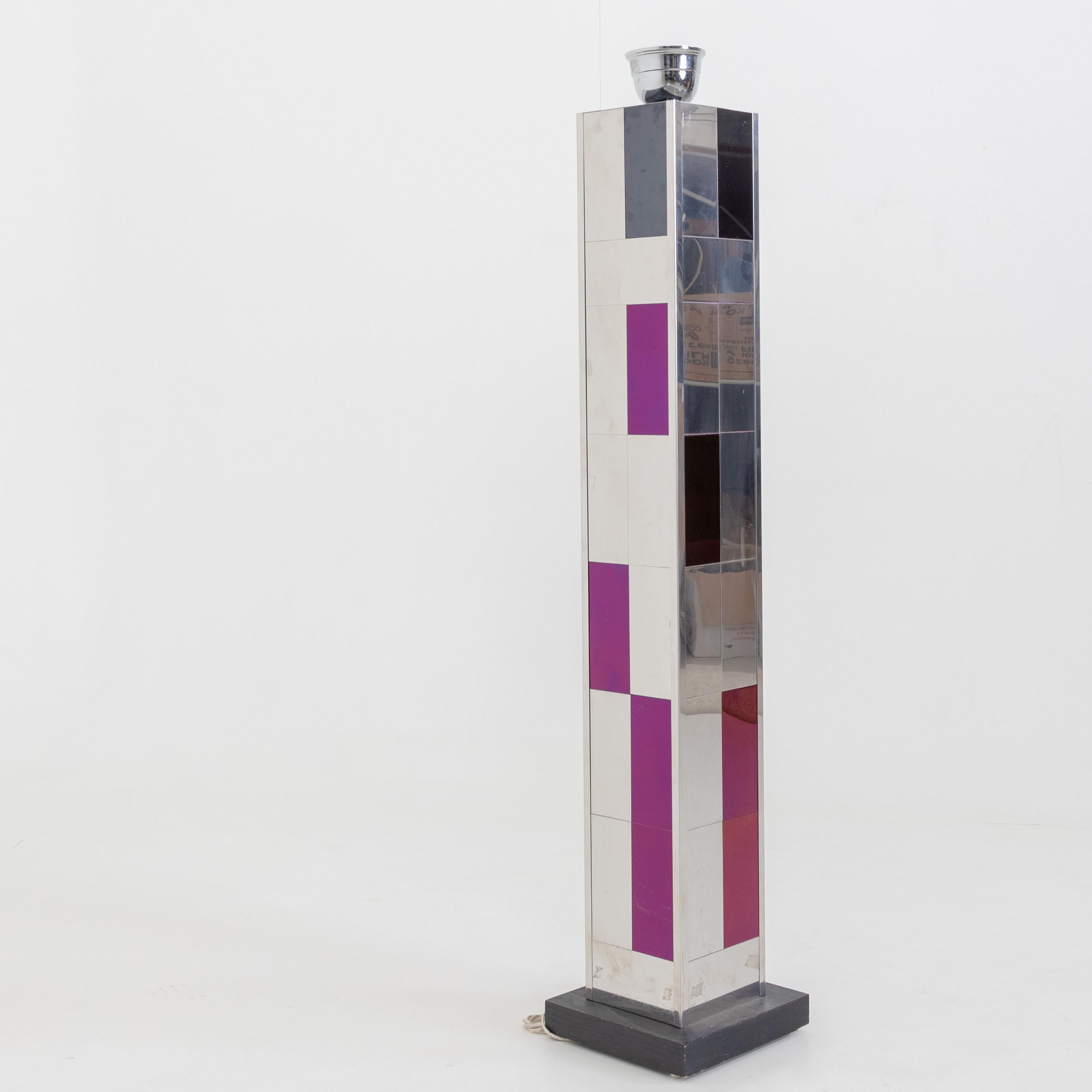 Large chrome floor lamp with purple fields and square base.