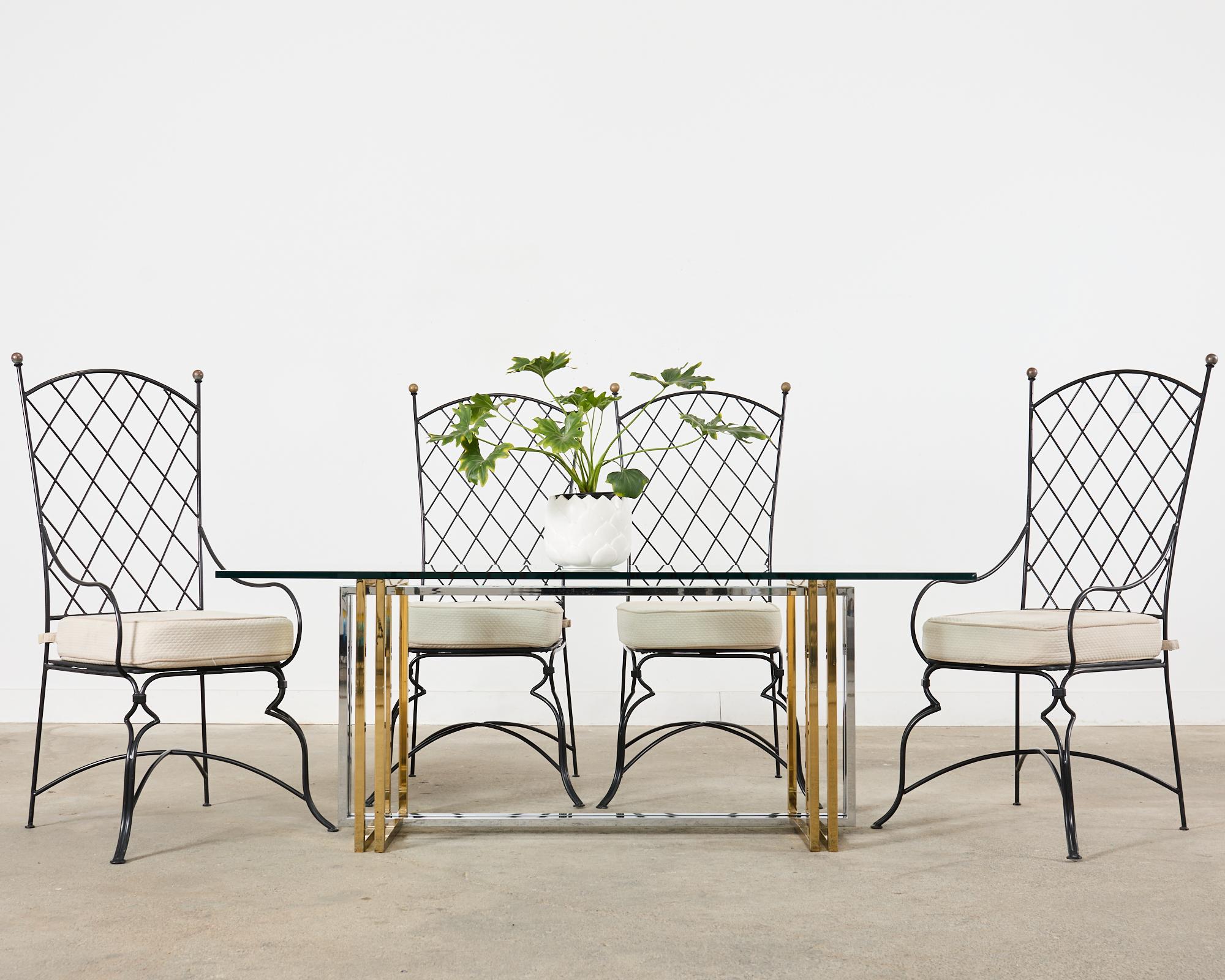 Stunning 20th century Hollywood Regency Italian dining table made in the style and manner of Romeo Rega. The table features a square tube steel frame in square and rectangular shapes. The brass finished square legs support the thick pane of glass.