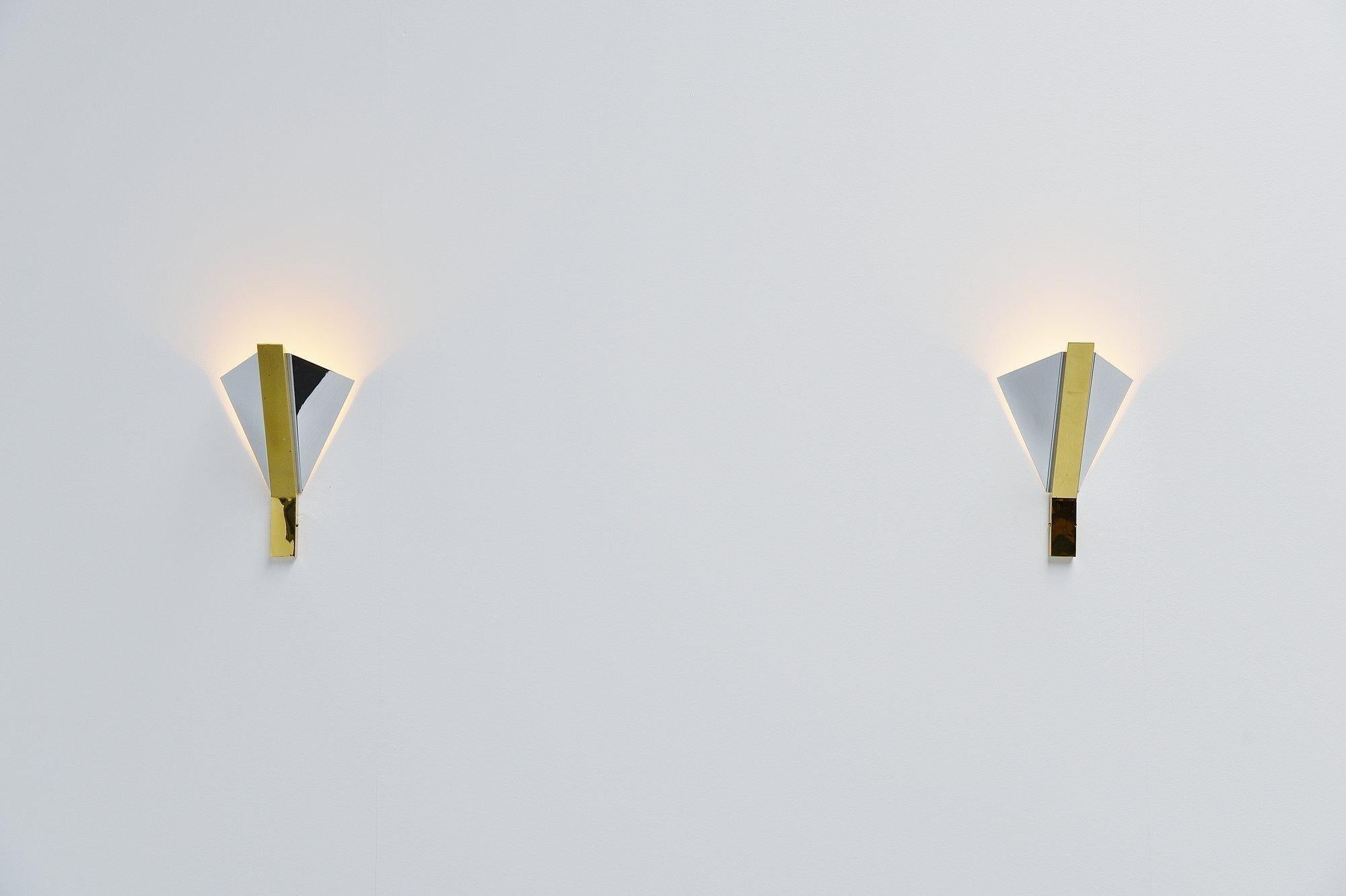 Very nice pair of sconces designed and manufactured by Romeo Rega, Italy 1970. These quality sconces have a very nice shape and are made of chrome and brass plated metal. The sconces are in excellent condition and give very nice sperical light when
