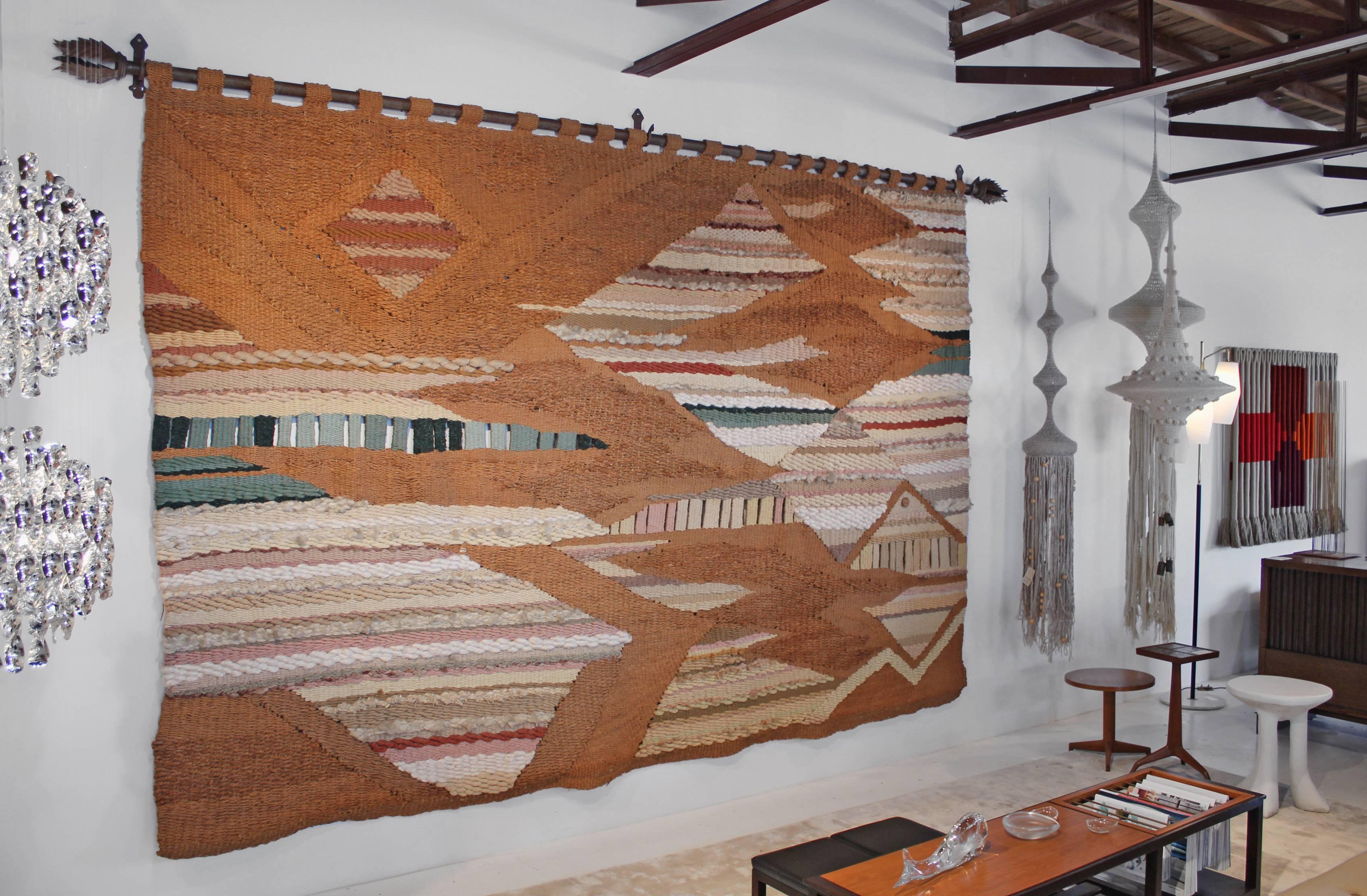 This massive raw fiber tapestry was woven by Romeo Reyna in the 1970s for a prominent family in Oklahoma. Romeo worked on the commission with the world-renowned interior designer Steve Chase. It has remained in the private collection of the family