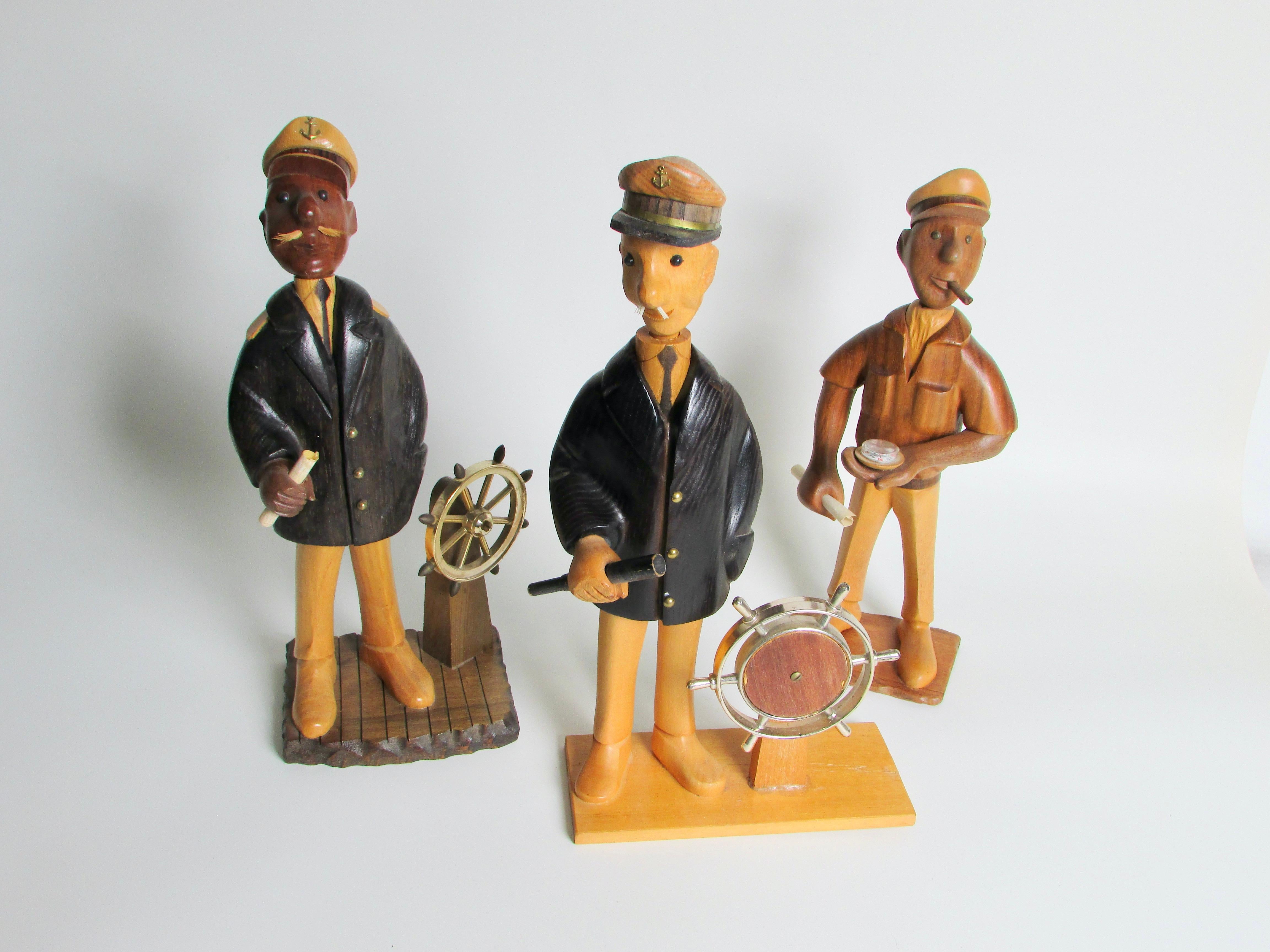 From a large collection of Romeor Italy hand carved sculptures . Fun and whimsical depictions of varied trades people , professionals , hobbyists . These three are sea faring men . Two captains and one sailor . Good condition . One captain has a