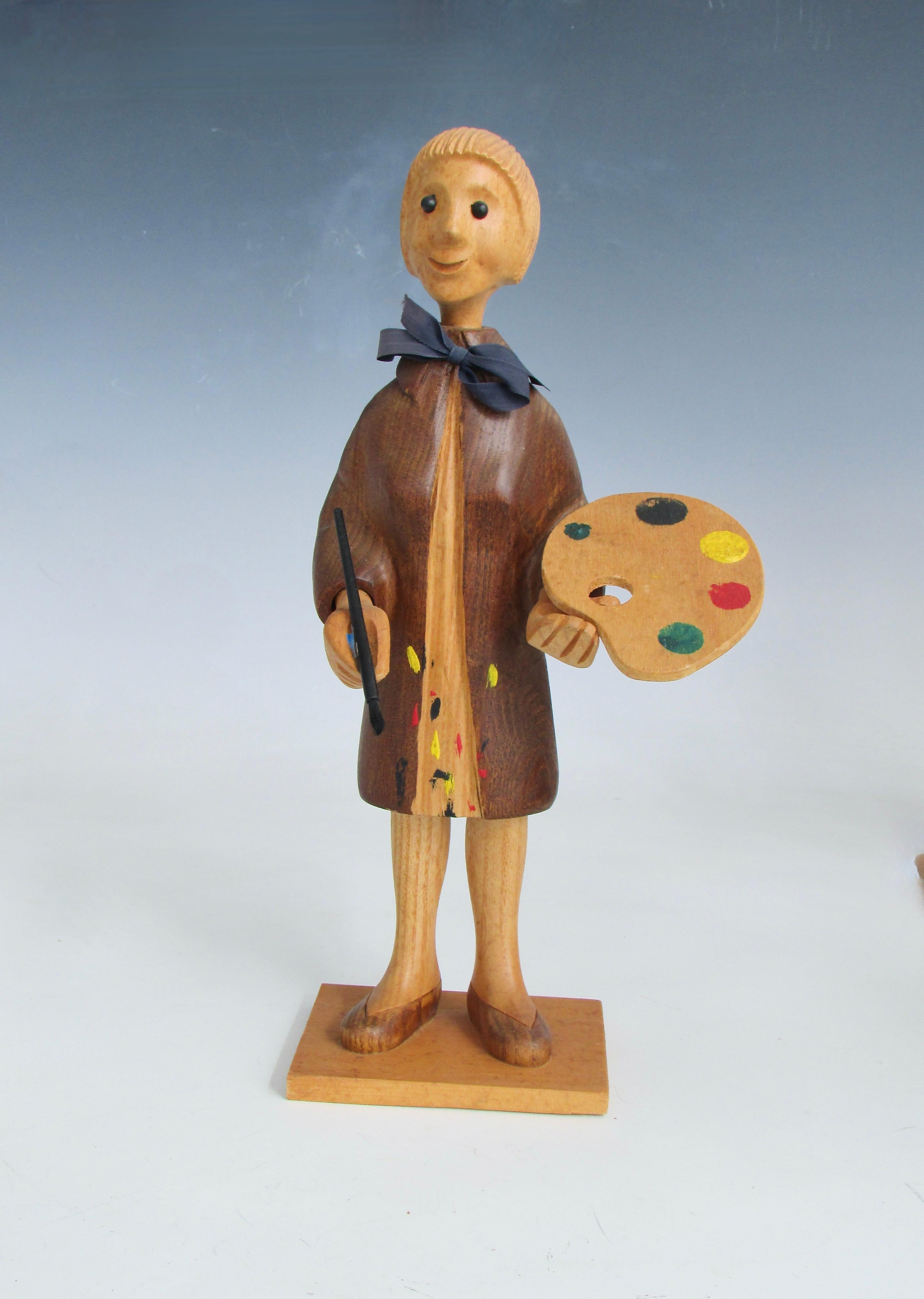 Whimsical carved figure of artist in smock with paint palette and brush . Hand carved in Italy late 1960s into the seventies . This is one of many carved figures depicting trades and hobbies . Made by Romer company  Italy . Sold originally in