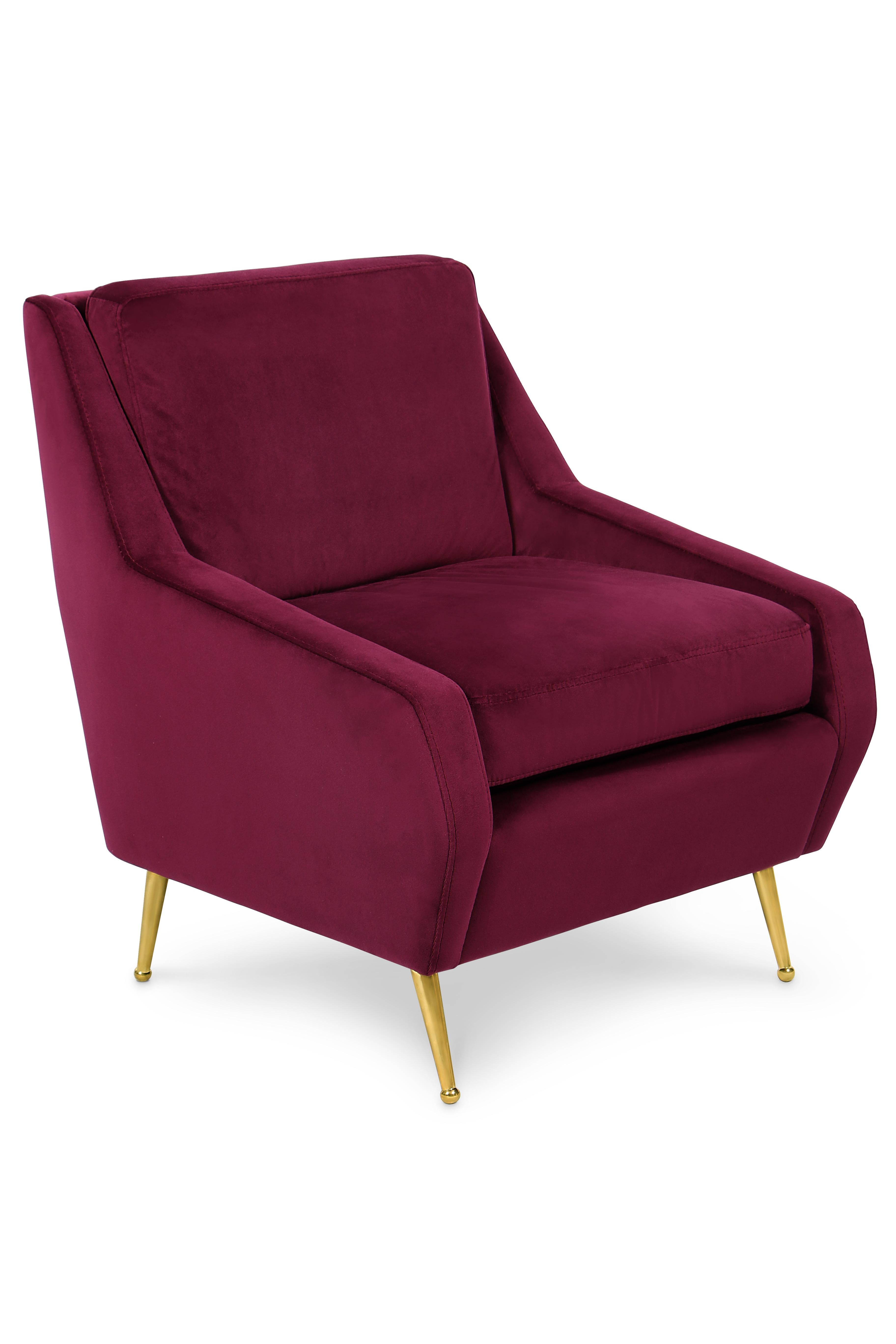 Romero is a lounge chair where the geometric sleek lines merge with comfort. It is inspired in the most bold side of modernism, featuring oblique armsrests with a fully upholstered body in velvet. It has a slim leg style made of polished brass and a