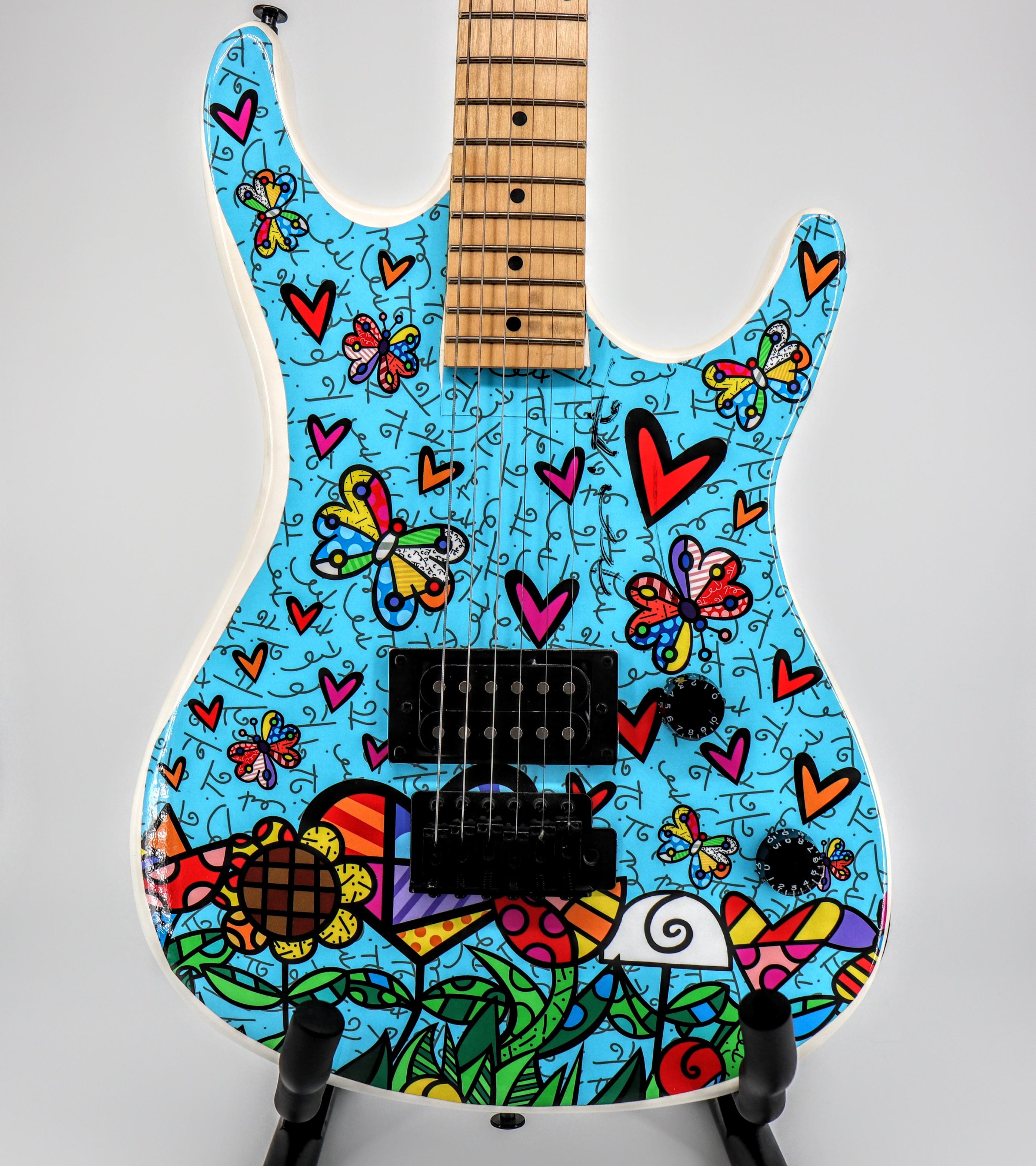 Artist: Romero Britto
Manufacturer: JB Guitars
Model: Viper
Guitar Total Length: 39"
Scale length: 25.5"
Electronics: Humbucker
Guitar bridge: Tremolo 6 Saddle bridge
Hardware color: Black
Guitar Neck: Maple
Fretboard: Maple
Body: White
Controls: 1