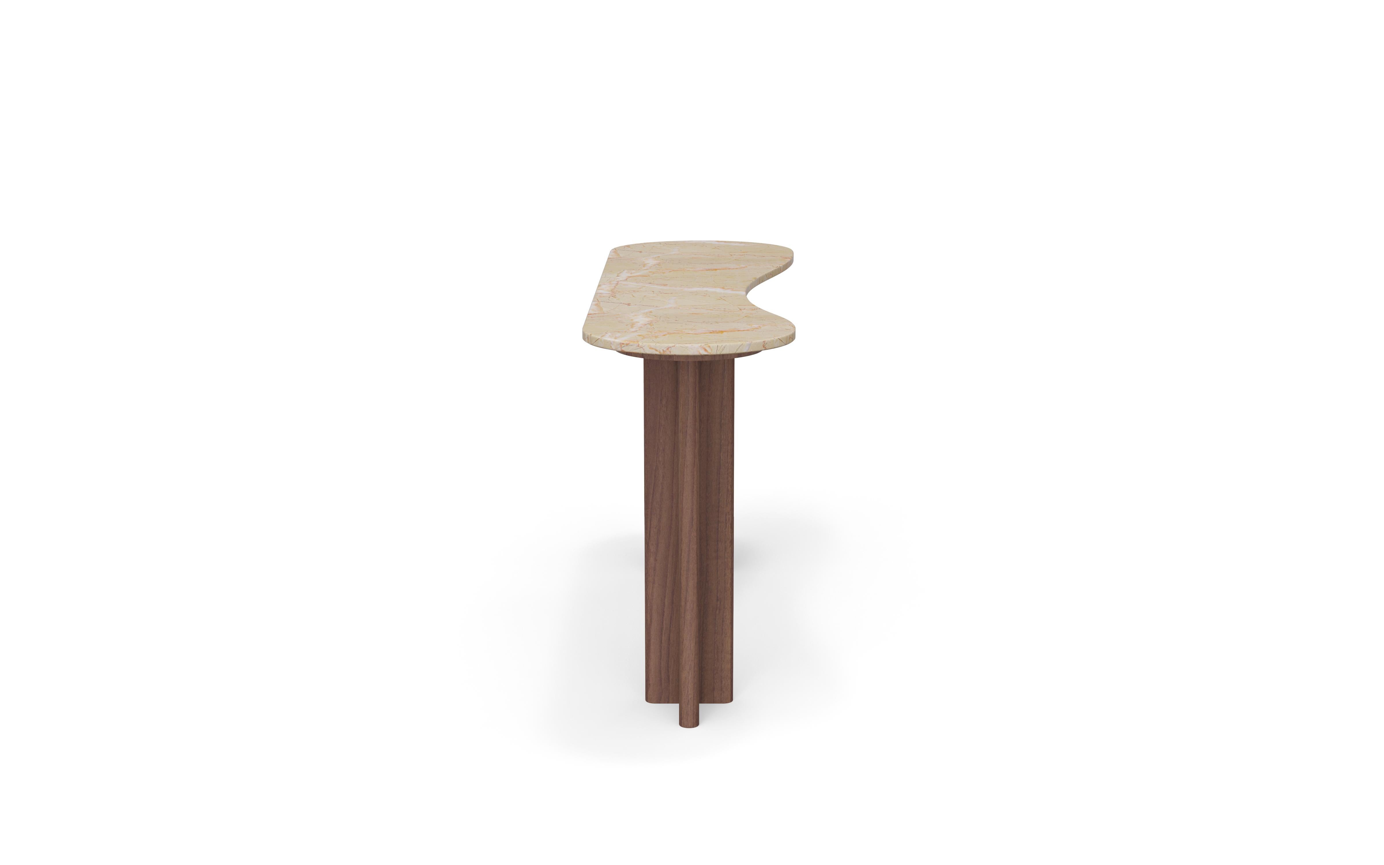 Romi Console establishes a restrained line in the entry, realised as an Alpinina marble and walnut console table that balances solidity and lightness. The top plane sets the tonal centre of the composition. The console is crafted with an honed stone