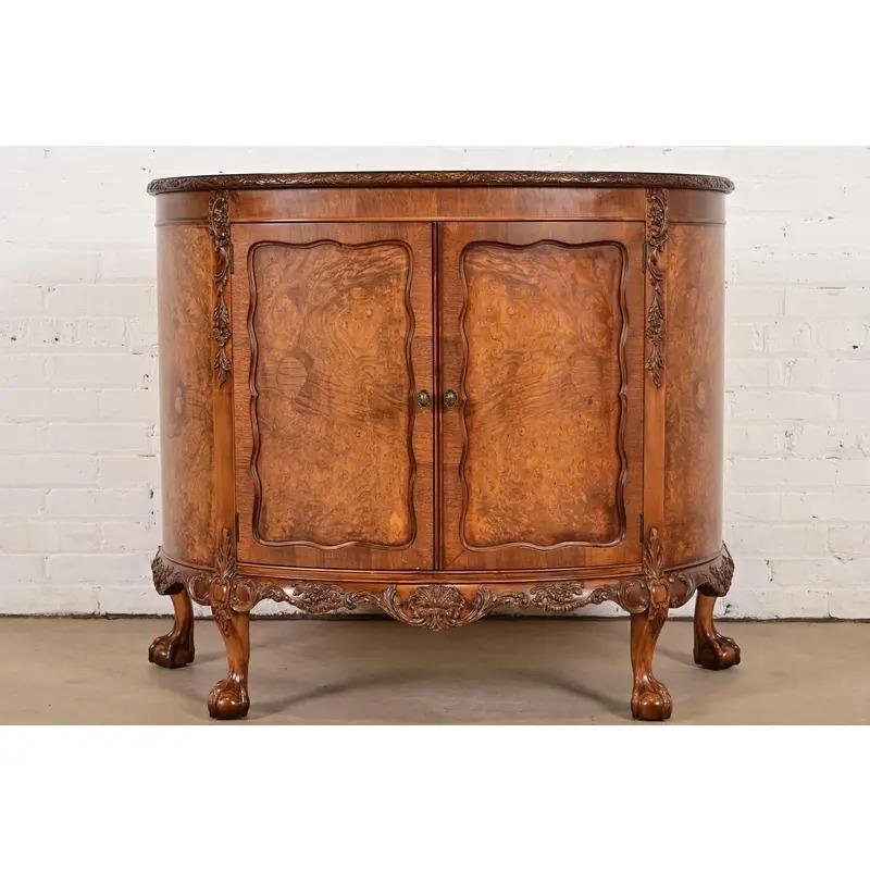An exceptional antique Chippendale or Georgian style demilune cabinet, console table, bar cabinet, or entry table

By Romweber

USA, Circa 1920s

Gorgeous book-matched burl wood, with original brass hardware.

Measures: 42.75