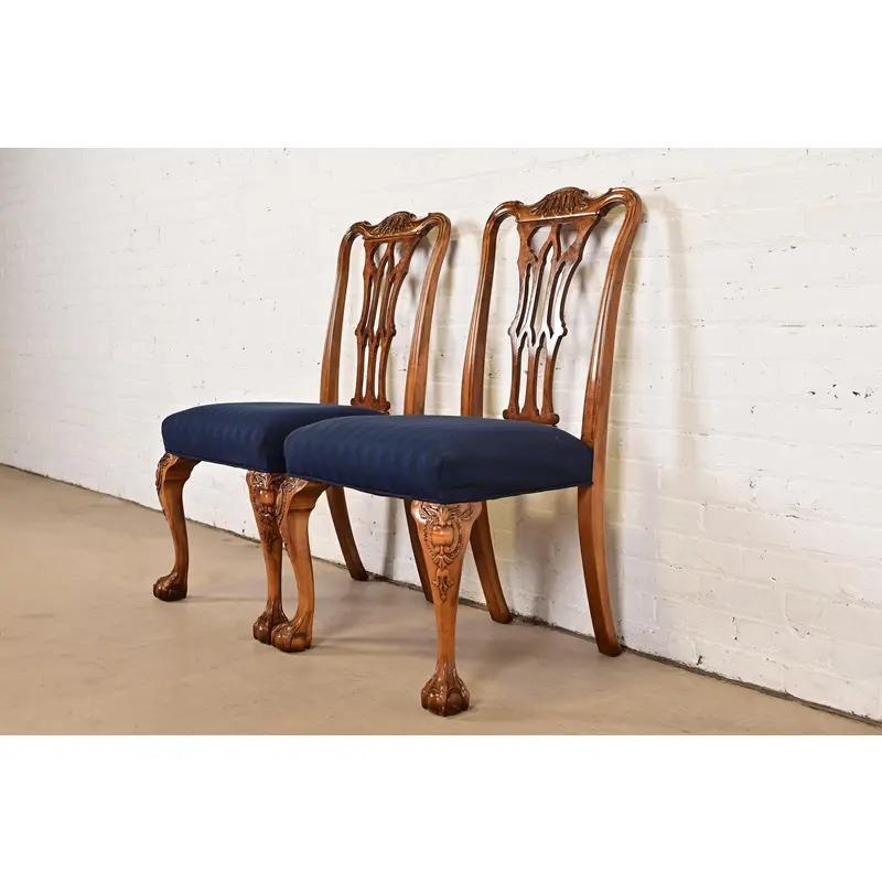 An outstanding pair of  or Georgian style dining chairs

By Romweber

USA, Circa 1920s

Carved walnut and burl wood frames, with ball and claw feet, and upholstered seats.

Measures: 23.25