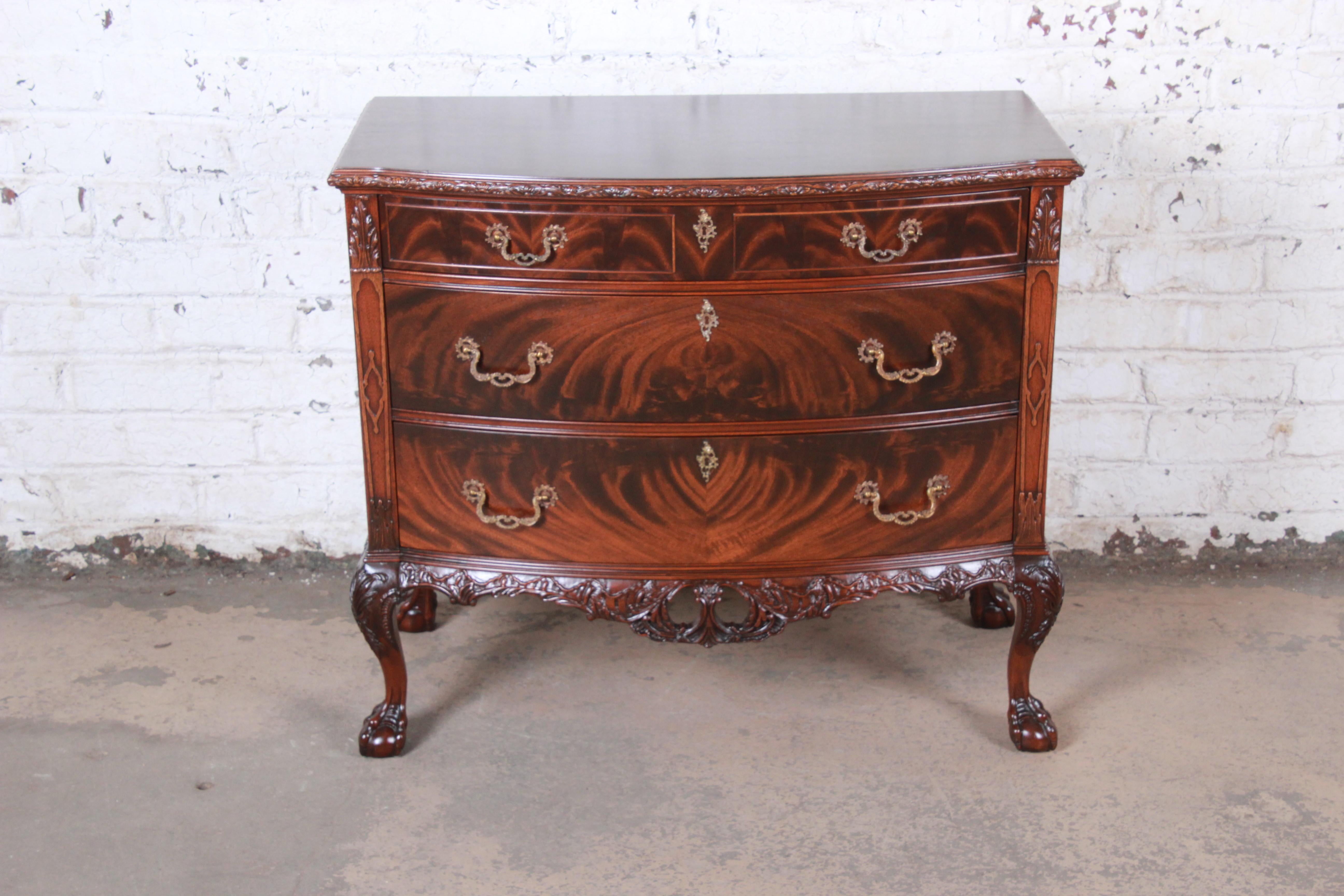 An exceptional newly restored Chippendale style ornate carved flame mahogany bow front buffet server, chest of drawers, or bar cabinet

By Romweber

USA, circa 1920s

Bookmatched flame mahogany and brass hardware

Measures: 40.5