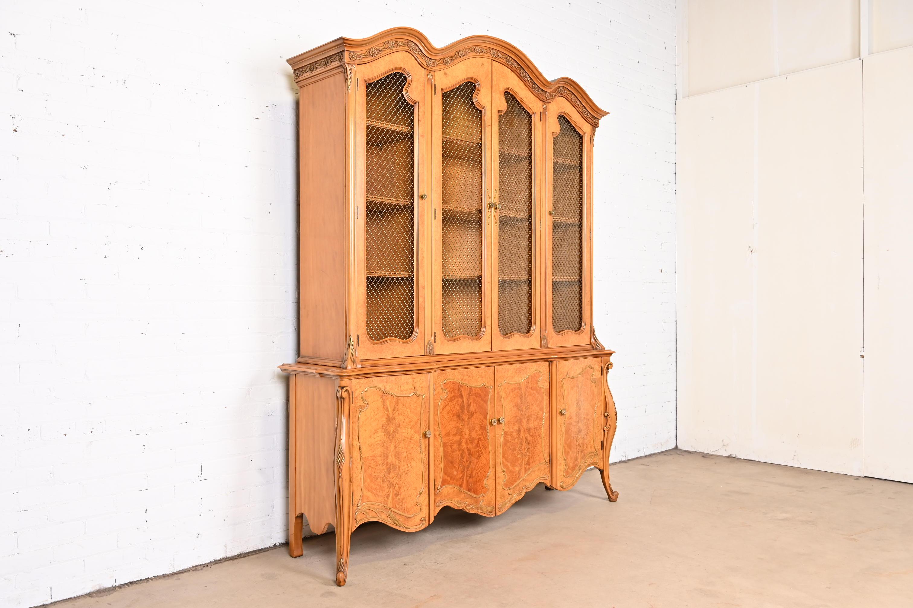 A gorgeous French Provincial Louis XV style two-piece breakfront bookcase or china cabinet

By Romweber

USA, circa 1950s

Satinwood, with beautiful burl wood front, glass front doors, and original brass hardware.

Measures: 68