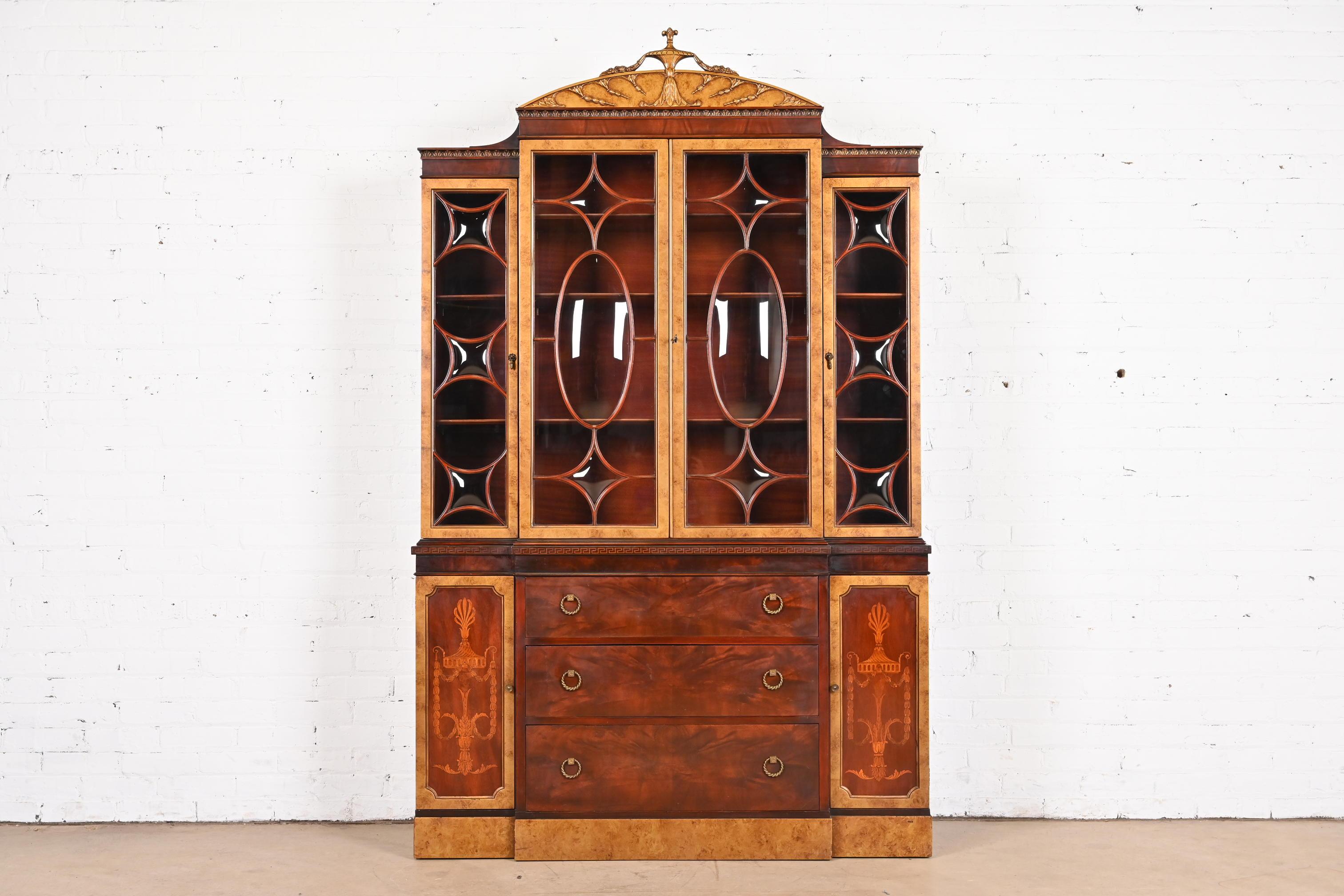 An outstanding French Neoclassical or Louis XVI style bubble glass breakfront bookcase cabinet or dining cabinet

By Romweber

USA, Circa 1930s

Gorgeous book-matched flame mahogany, with burled olive wood, inlaid satinwood marquetry and Greek key