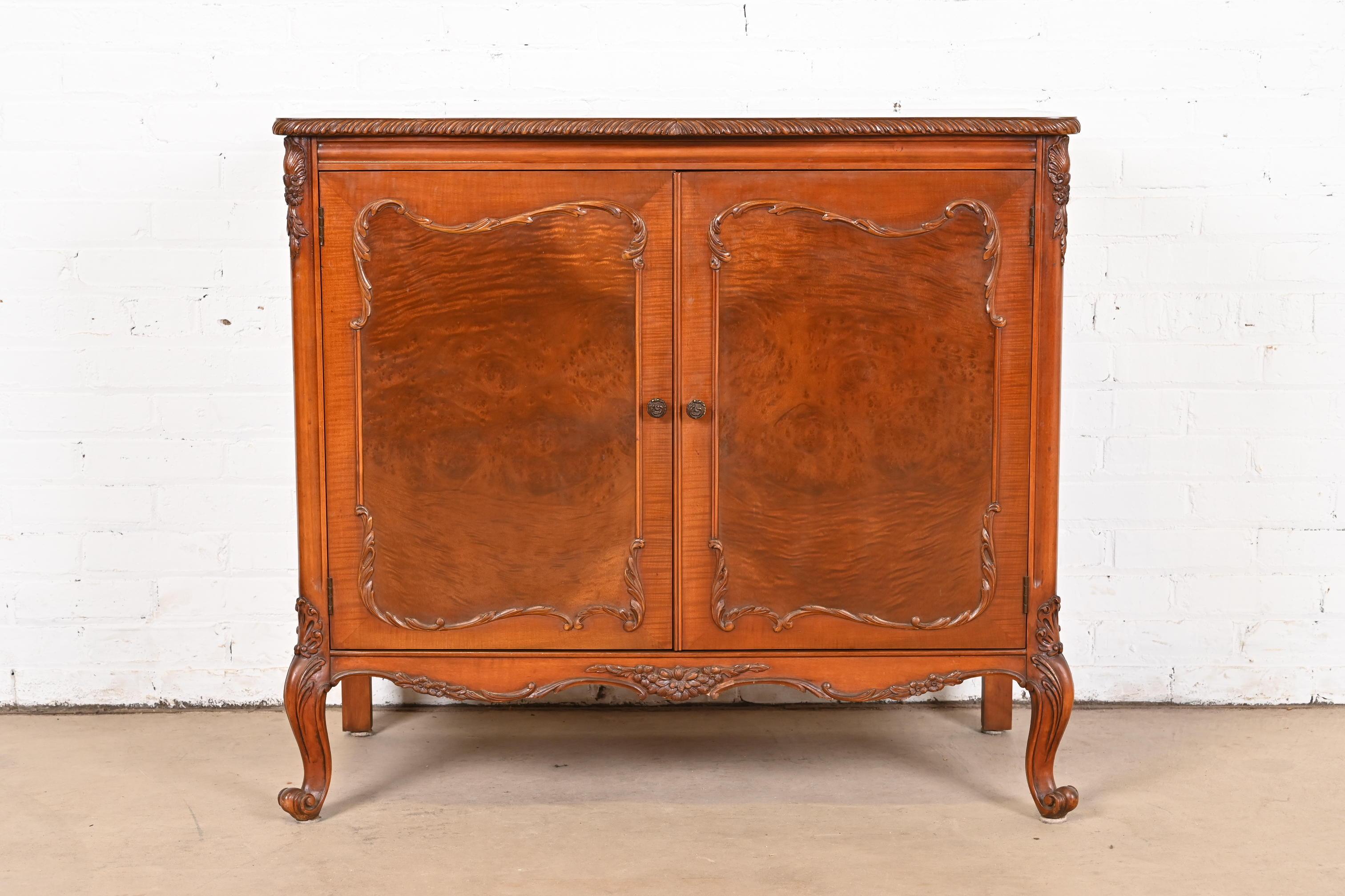 An exceptional French Provincial Louis XV style buffet server or bar cabinet

By Romweber

USA, Circa 1920s

Gorgeous exotic burled acacia wood, with original brass hardware.

Measures: 39