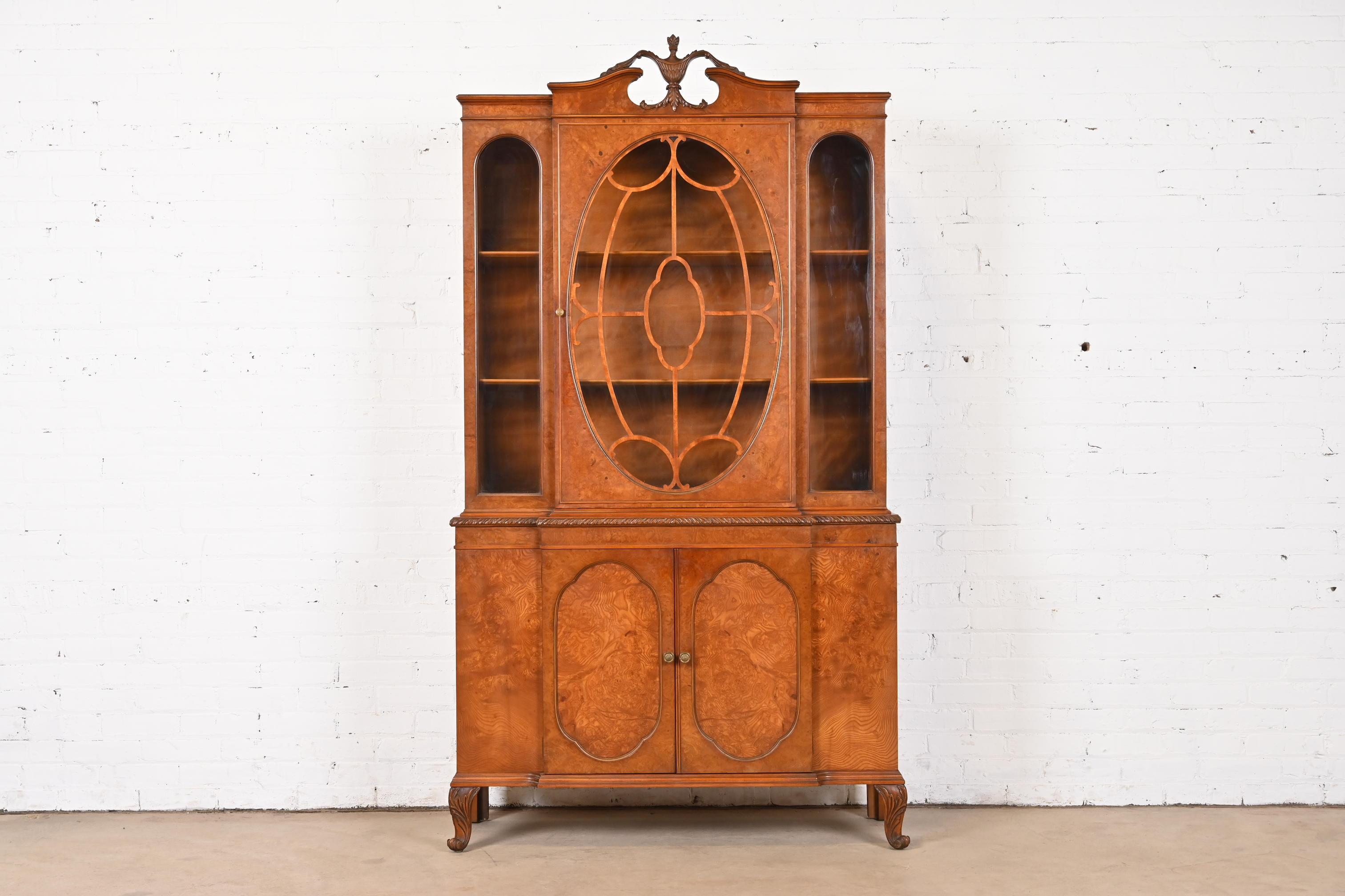An exceptional French Provincial Louis XV style breakfront bookcase cabinet or dining cabinet

By Romweber

USA, Circa 1920s

Gorgeous burled olive wood, with mullioned glass front doors, and original brass hardware.

Measures: 44