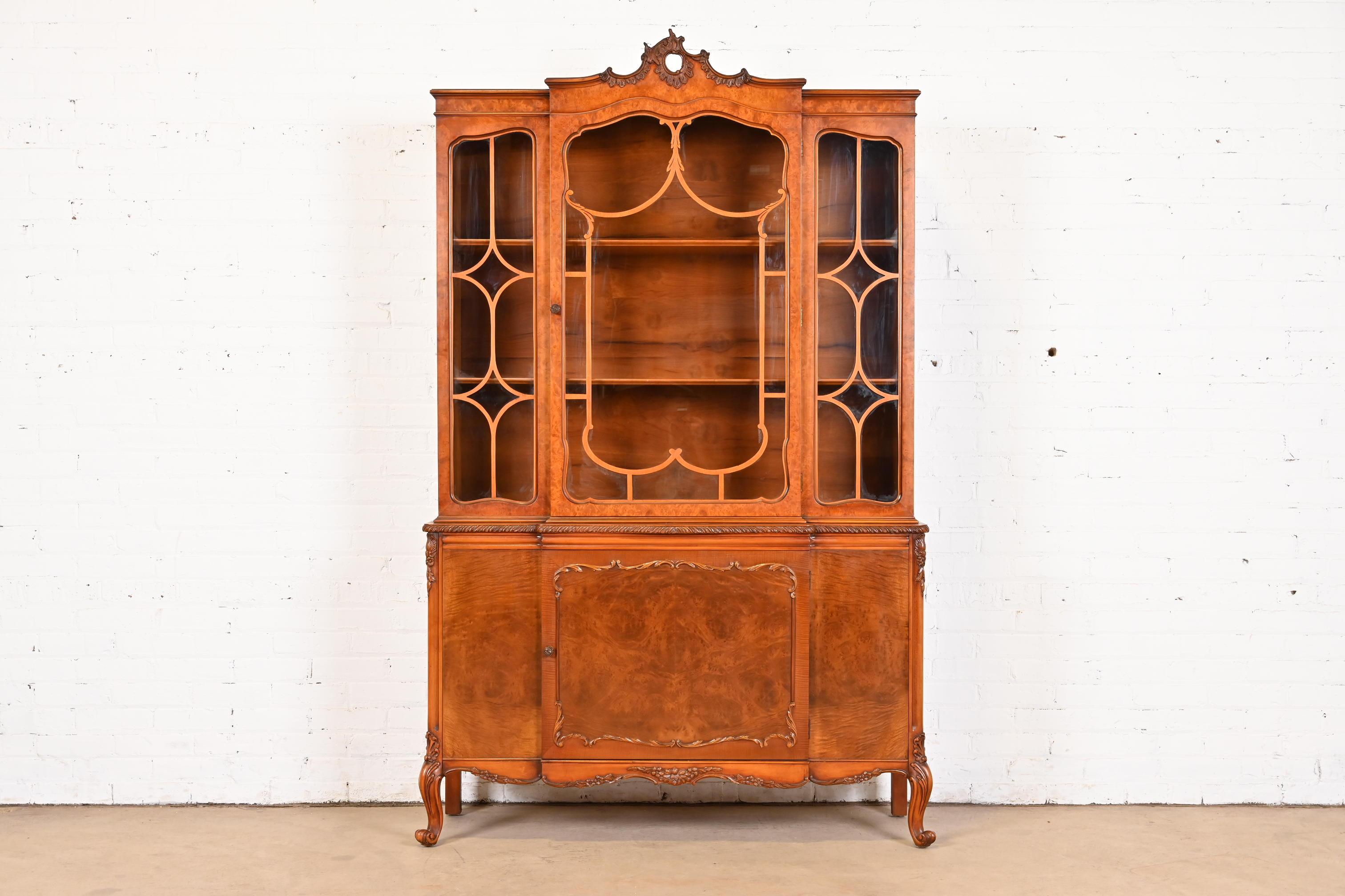 An exceptional French Provincial Louis XV style breakfront bookcase cabinet or dining cabinet

By Romweber

USA, Circa 1920s

Gorgeous book-matched exotic burled acacia wood, with mullioned glass front doors, and original brass hardware.

Measures: