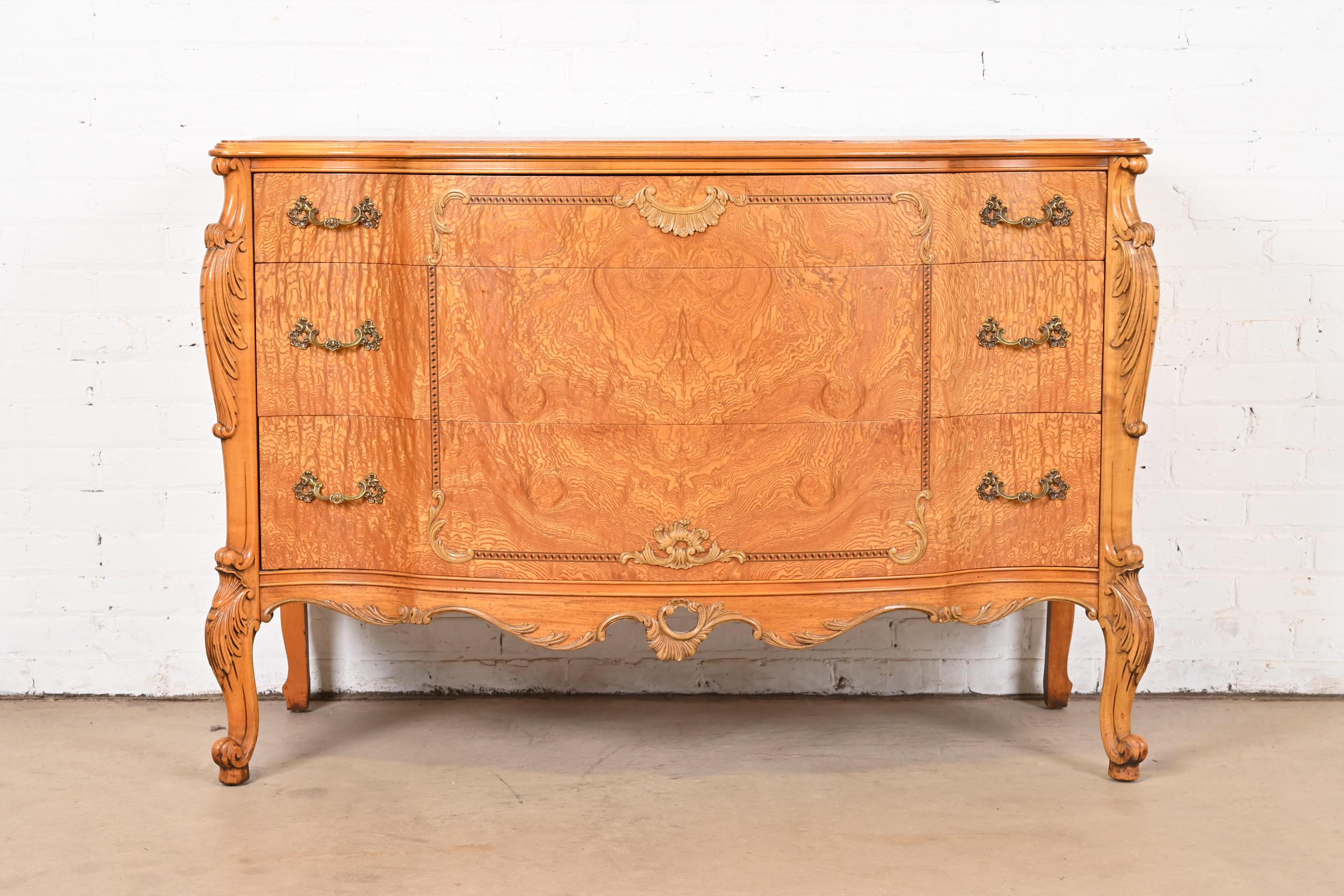 An exceptional French Provincial Louis XV style dresser or chest of drawers

By Romweber

USA, Circa 1920s

Stunning book-matched exotic burled Narra wood, with carved cabriole legs, and original brass hardware.

Measures: 51