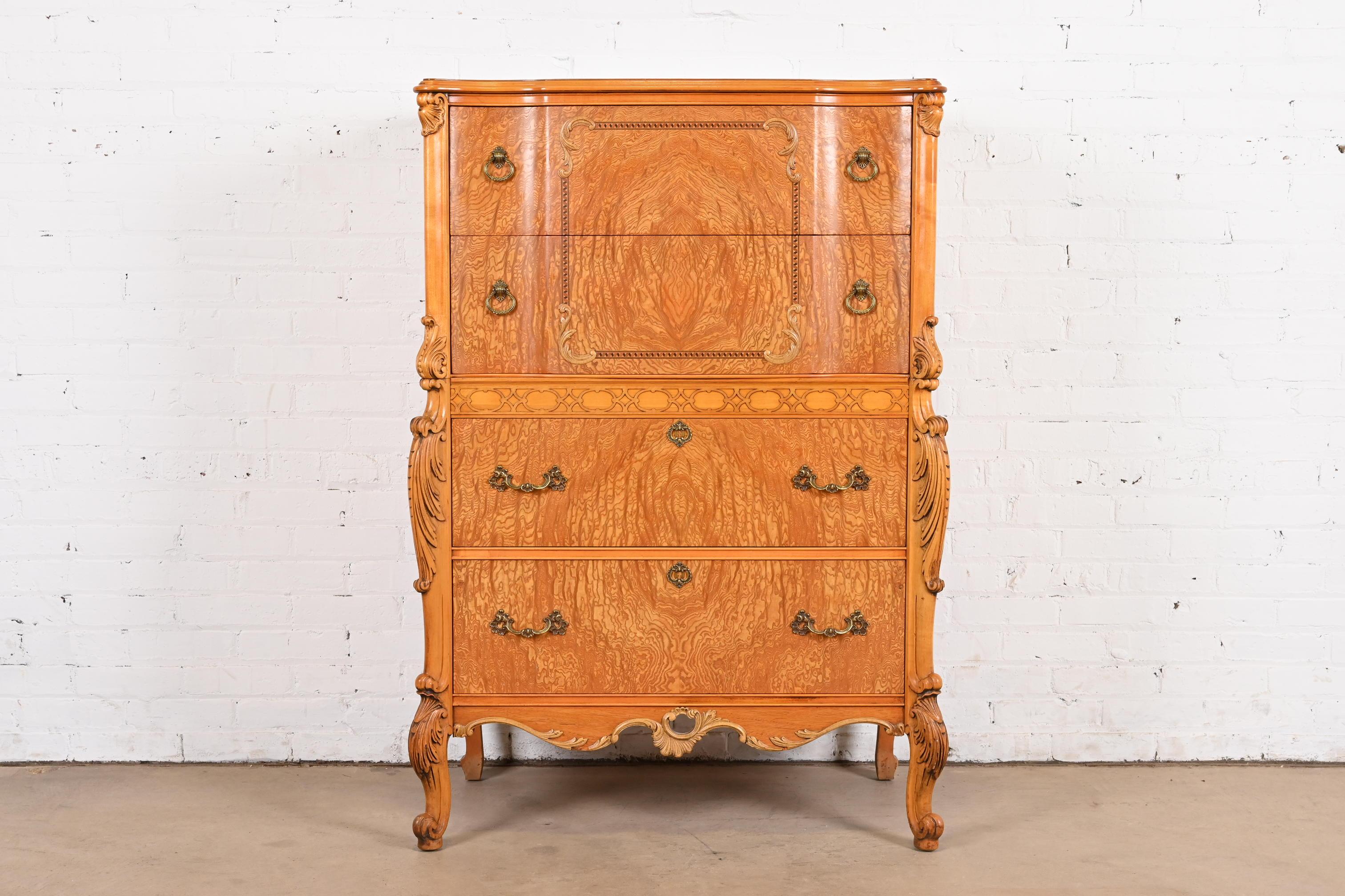 An exceptional French Provincial Louis XV style highboy dresser

By Romweber

USA, Circa 1920s

Stunning book-matched exotic burled Narra wood, with carved cabriole legs, and original brass hardware.

Measures: 35