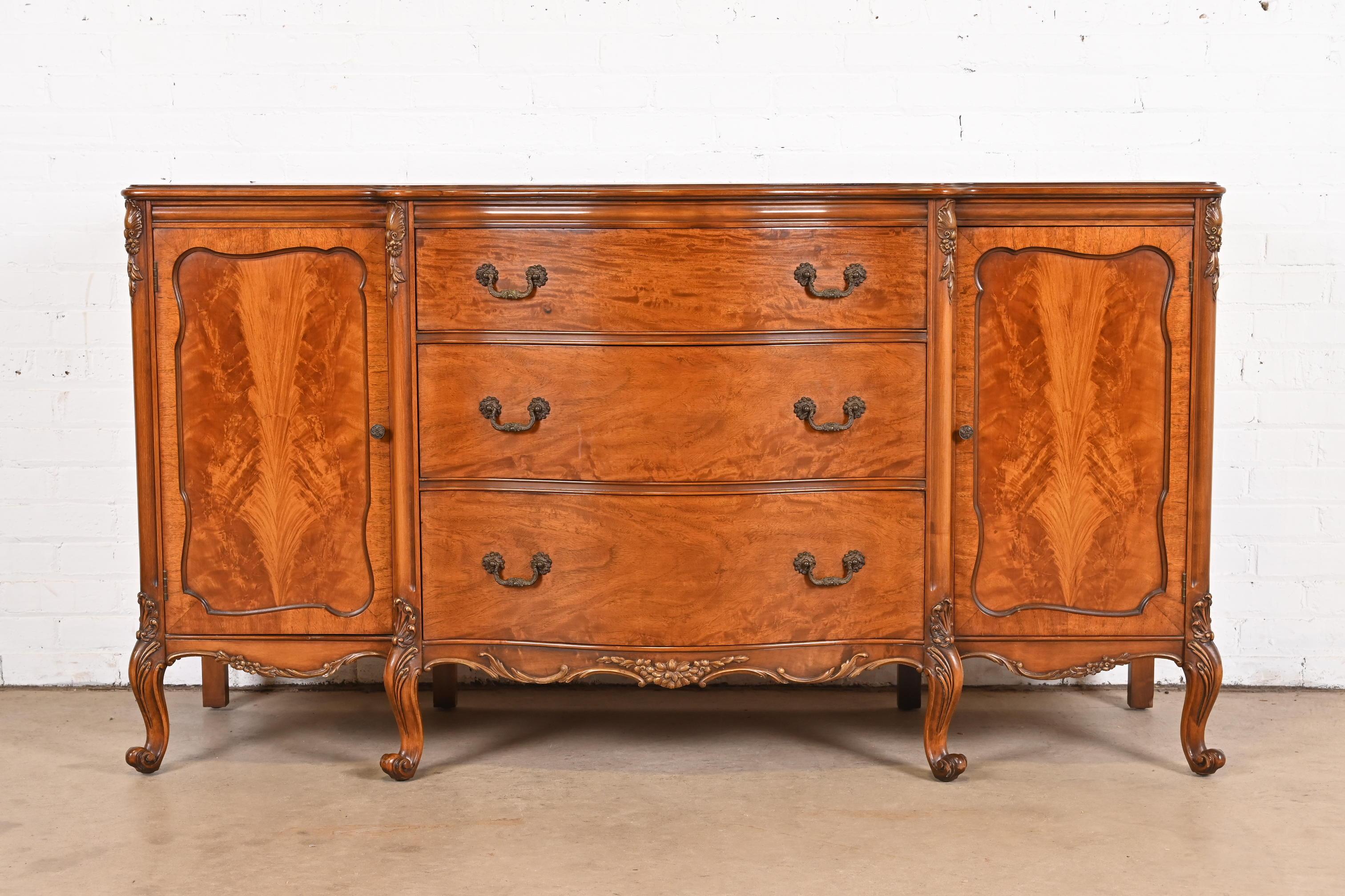 An exceptional French Provincial Louis XV style sideboard, credenza, or bar cabinet

By Romweber

USA, Circa 1920s

Stunning exotic burled Narra wood, with carved cabriole legs, and original brass harware.

Measures: 66