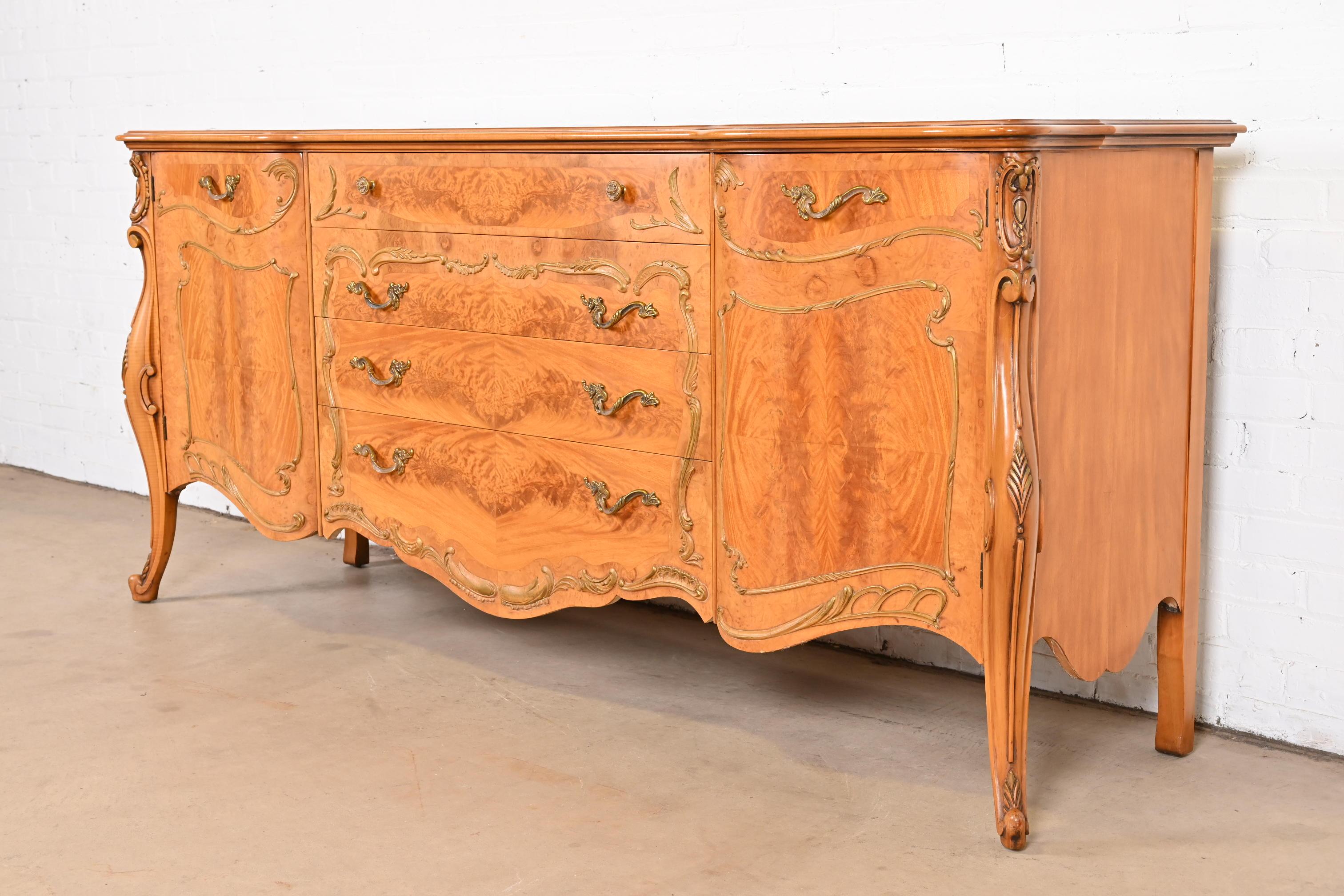 A gorgeous French Provincial Louis XV style sideboard, credenza, or bar cabinet

By Romweber

USA, circa 1940s

Exotic African Avodire wood, with beautiful burl wood front, and original brass hardware.

Measures: 79.75