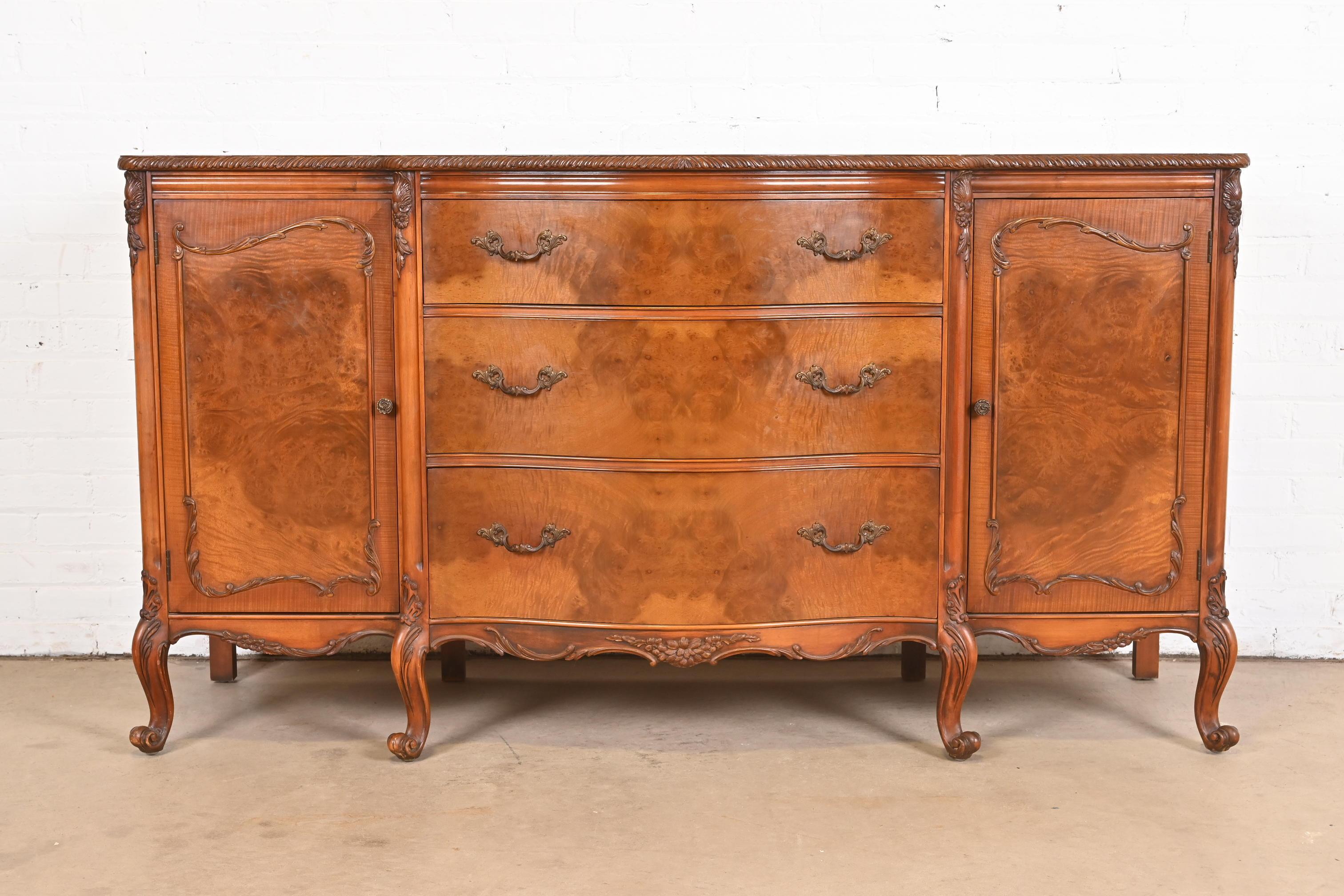 An exceptional French Provincial Louis XV style sideboard, credenza, or bar cabinet

By Romweber

USA, Circa 1920s

Gorgeous book-matched exotic burled acacia wood, with carved cabriole legs, and original brass hardware.

Measures: 66.5