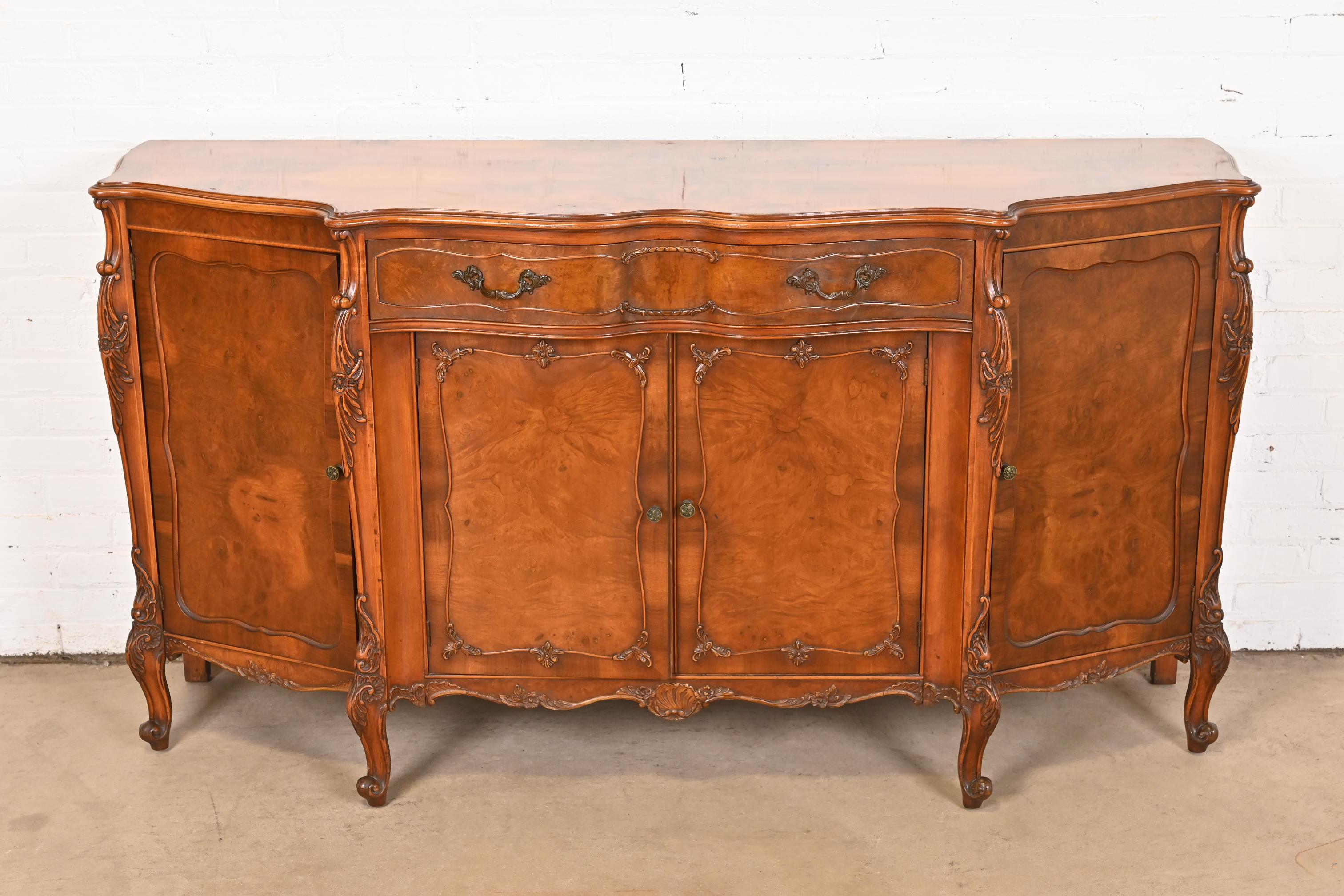 An exceptional French Provincial Louis XV style sideboard, credenza, or bar cabinet

By Romweber

USA, Circa 1920s

Gorgeous book-matched exotic burled acacia wood, with carved cabriole legs, and original brass hardware.

Measures: 66.5