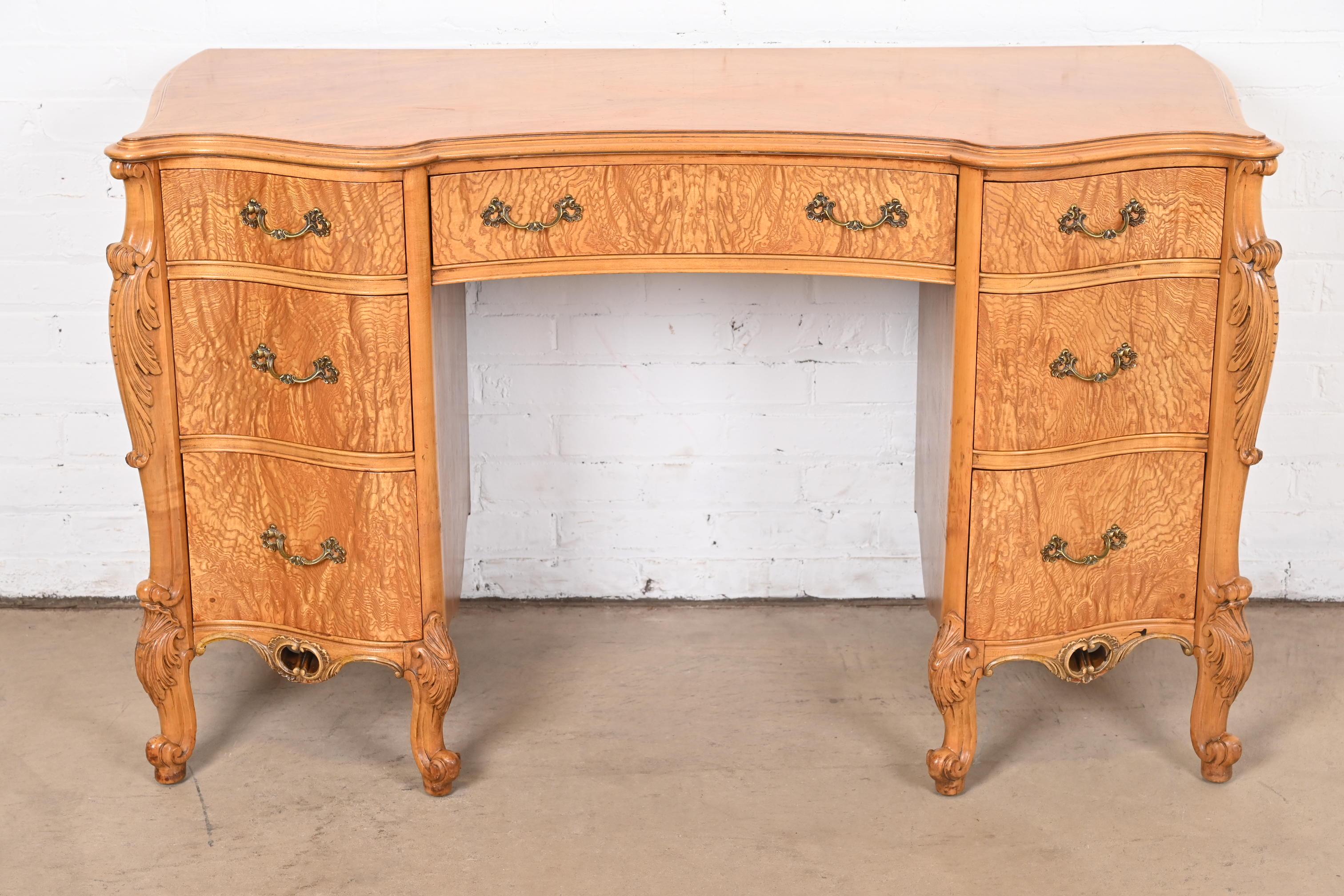 An exceptional French Provincial Louis XV style vanity or writing desk

By Romweber

USA, Circa 1920s

Stunning book-matched exotic burled Narra wood, with carved cabriole legs, and original brass hardware.

Measures: 49.5