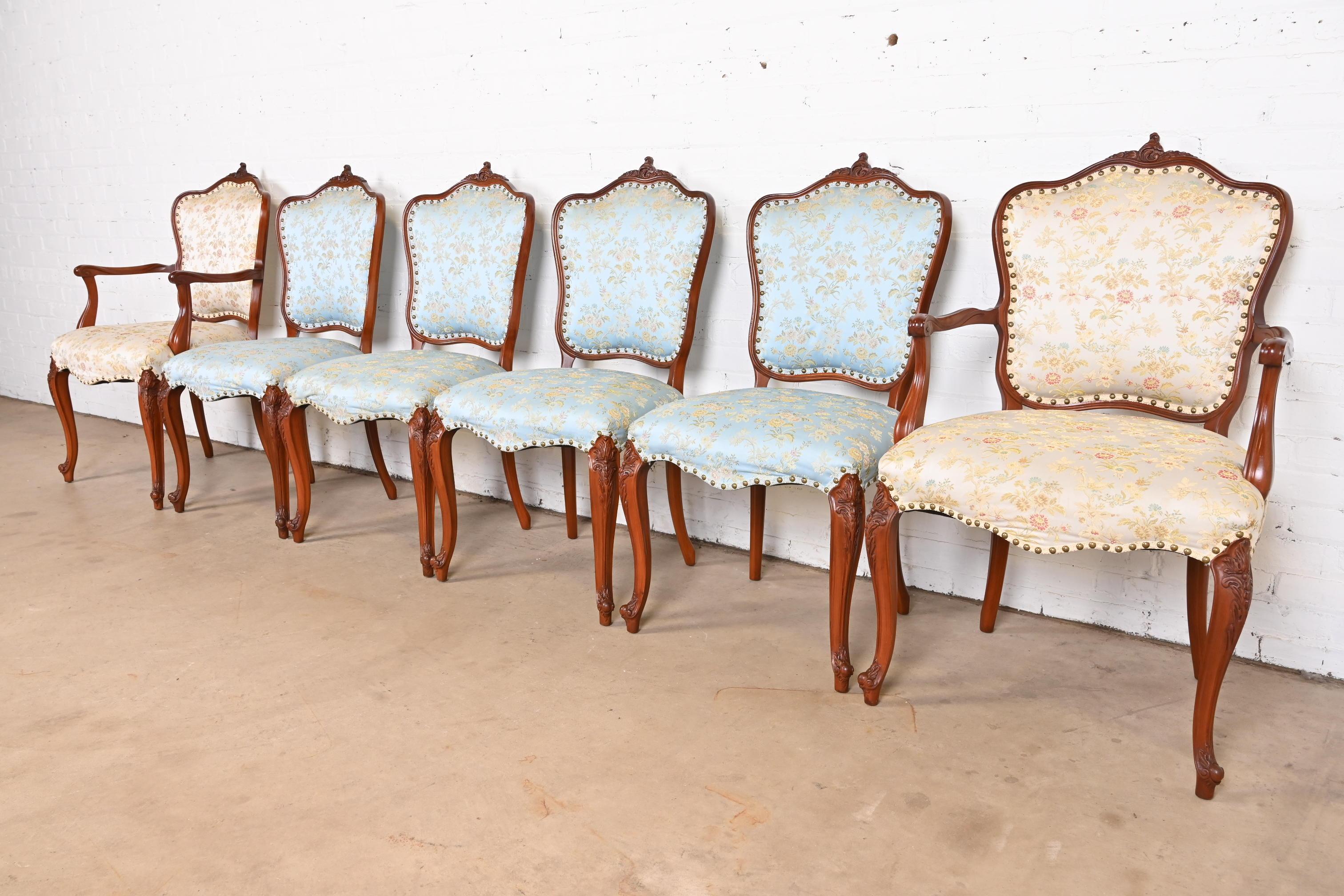 An outstanding set of six French Provincial Louis XV style dining chairs

By Romweber

USA, Circa 1920s

Gorgeous carved solid rosewood frames, with floral patterned silk upholstered seats and backs.

Measures:
Side Chairs: 21
