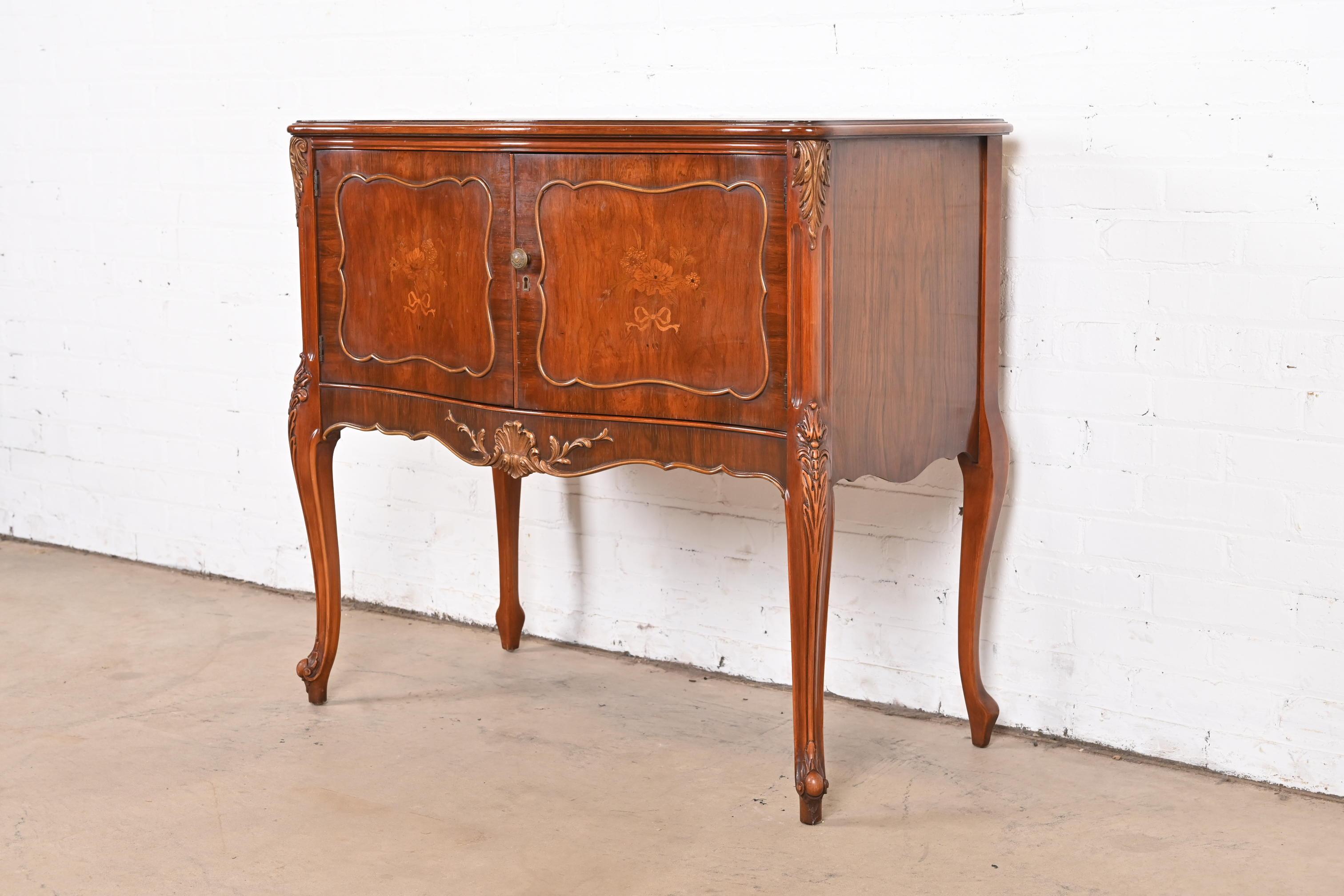 An exceptional French Provincial Louis XV style sideboard, server, or bar cabinet

By Romweber

USA, Circa 1920s

Gorgeous carved rosewood, with inlaid satinwood floral marquetry, and original brass hardware. Custom removable glass top is