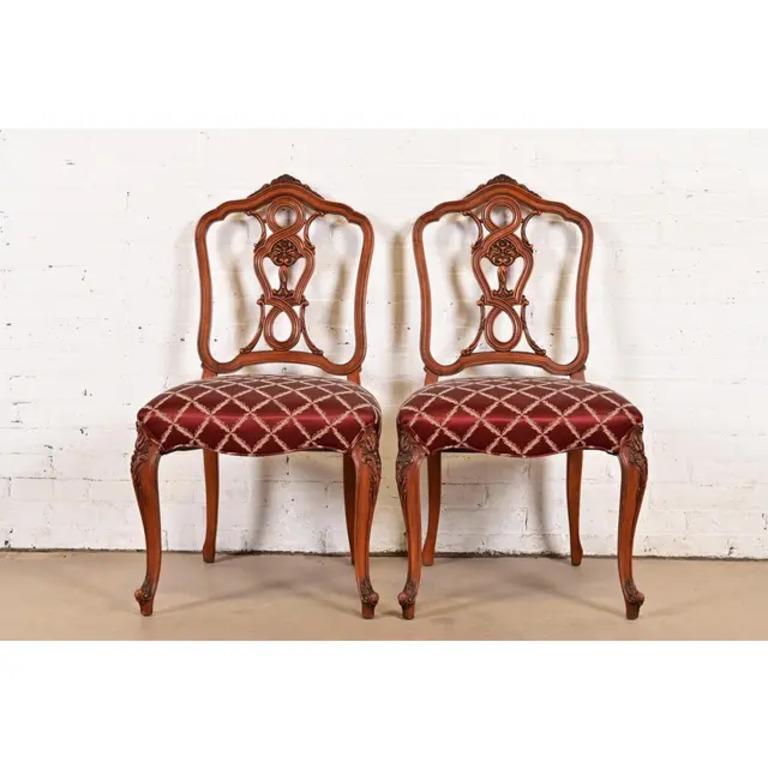 A gorgeous pair of French Provincial Louis XV style side chairs or dining chairs

By Romweber

USA, Circa 1920s

Solid carved walnut frames, with upholstered seats.

Measures: 21.75