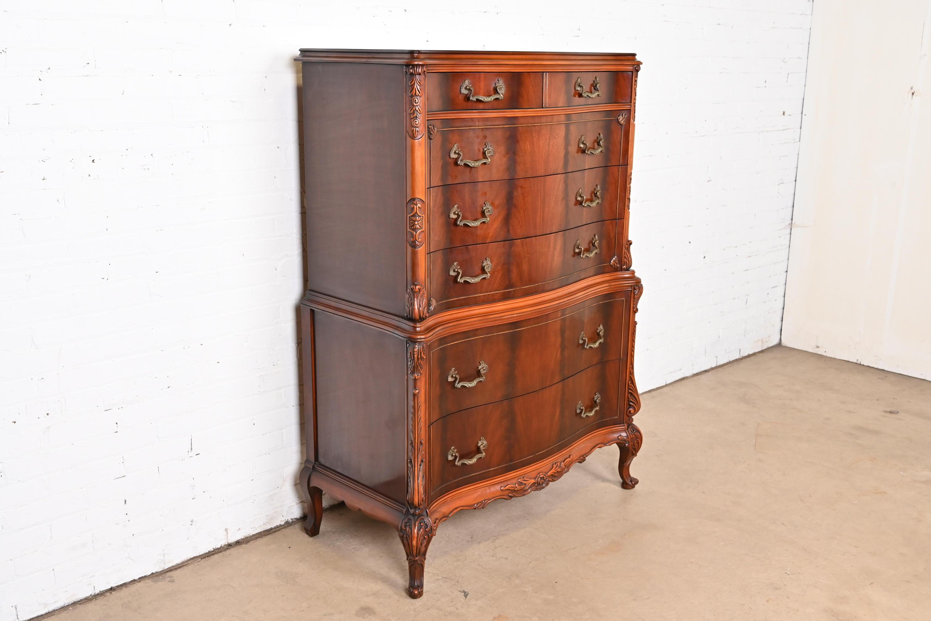 A gorgeous French Provincial Louis XV style highboy dresser or chest of drawers

By Romweber

USA, Circa 1920s

Stunning carved and book-matched flame mahogany, with original brass hardware. 

Measures: 43.75